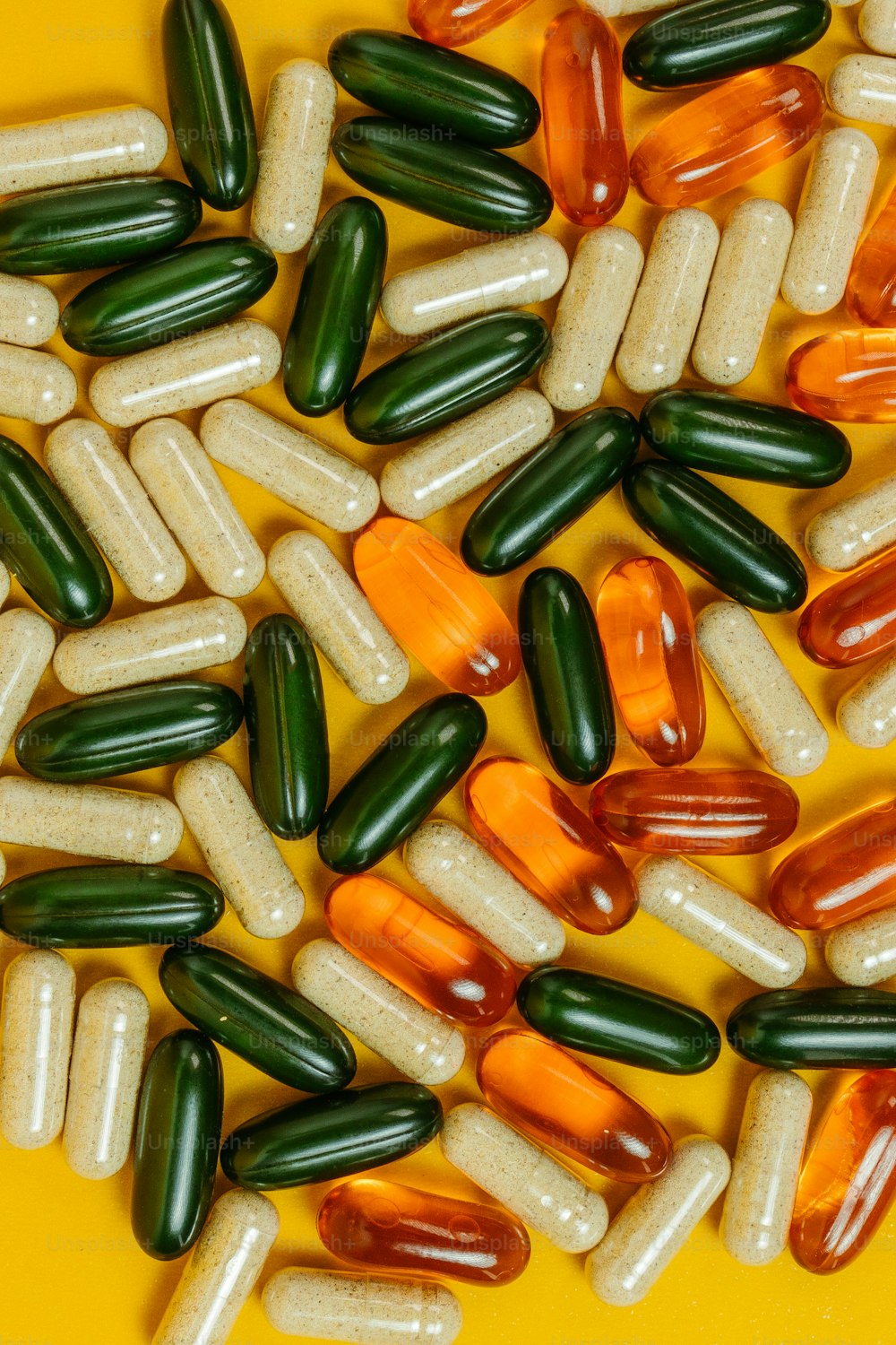 a pile of pills sitting on top of a yellow table