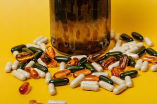 a bottle filled with pills sitting on top of a yellow table
