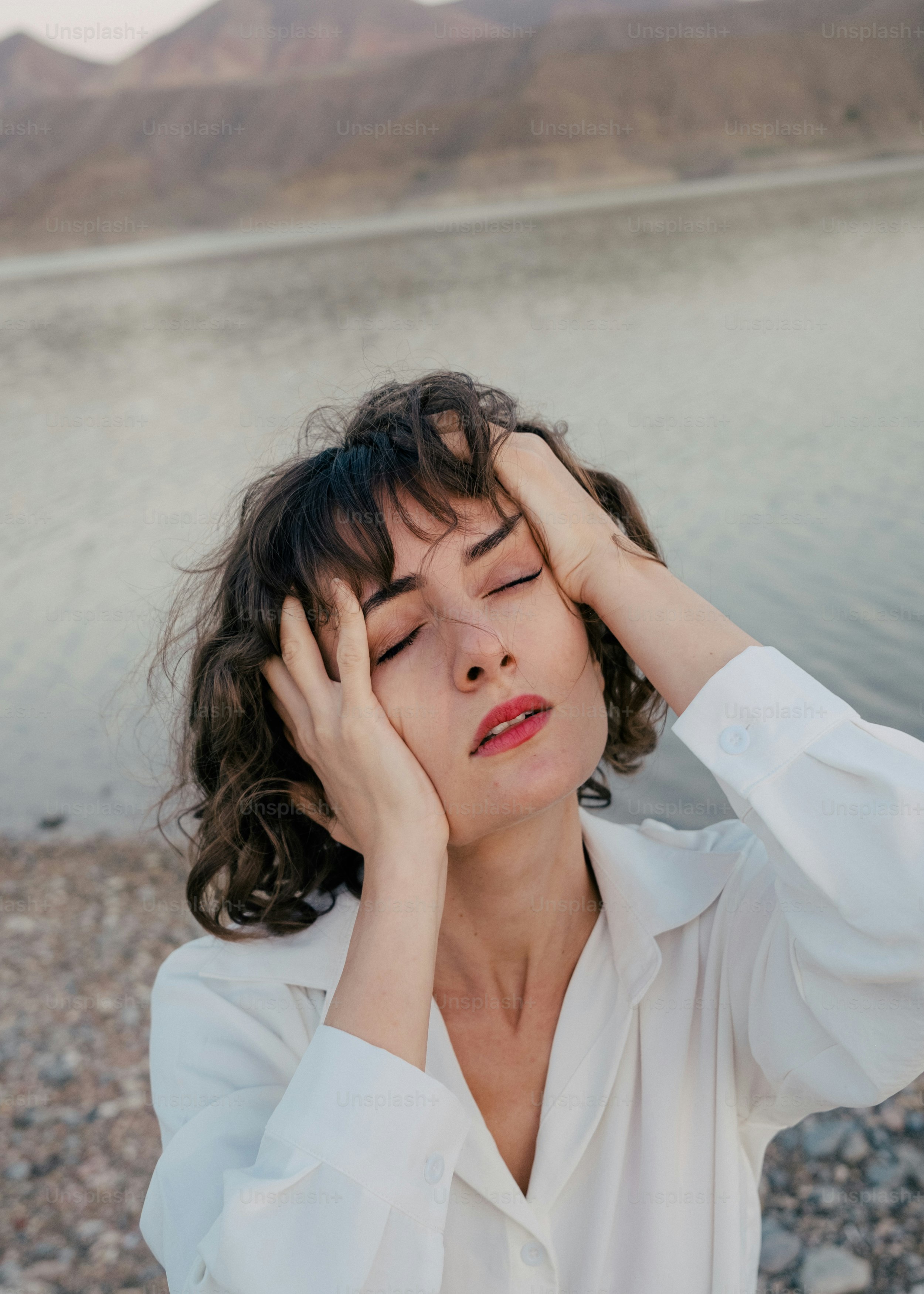 A woman is holding her head in her hands photo – Portrait Image on Unsplash