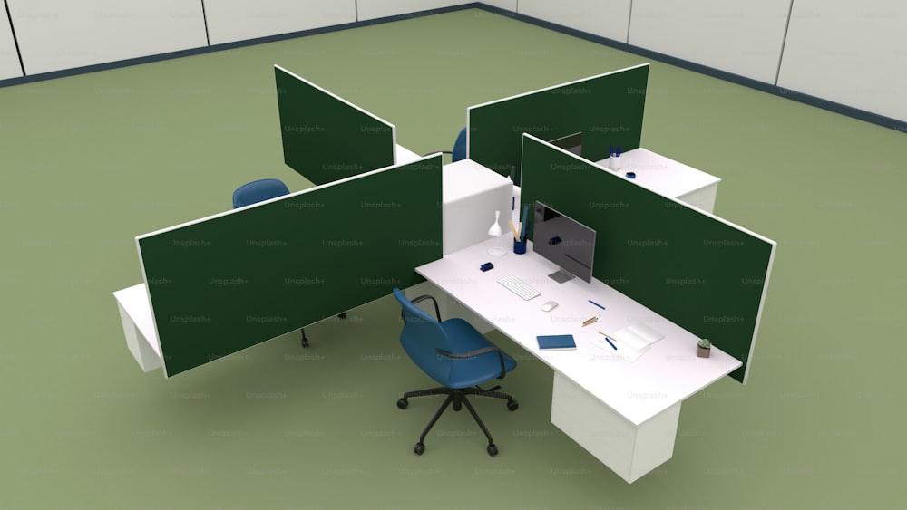 um cubículo de escritório com duas telas verdes e uma cadeira azul