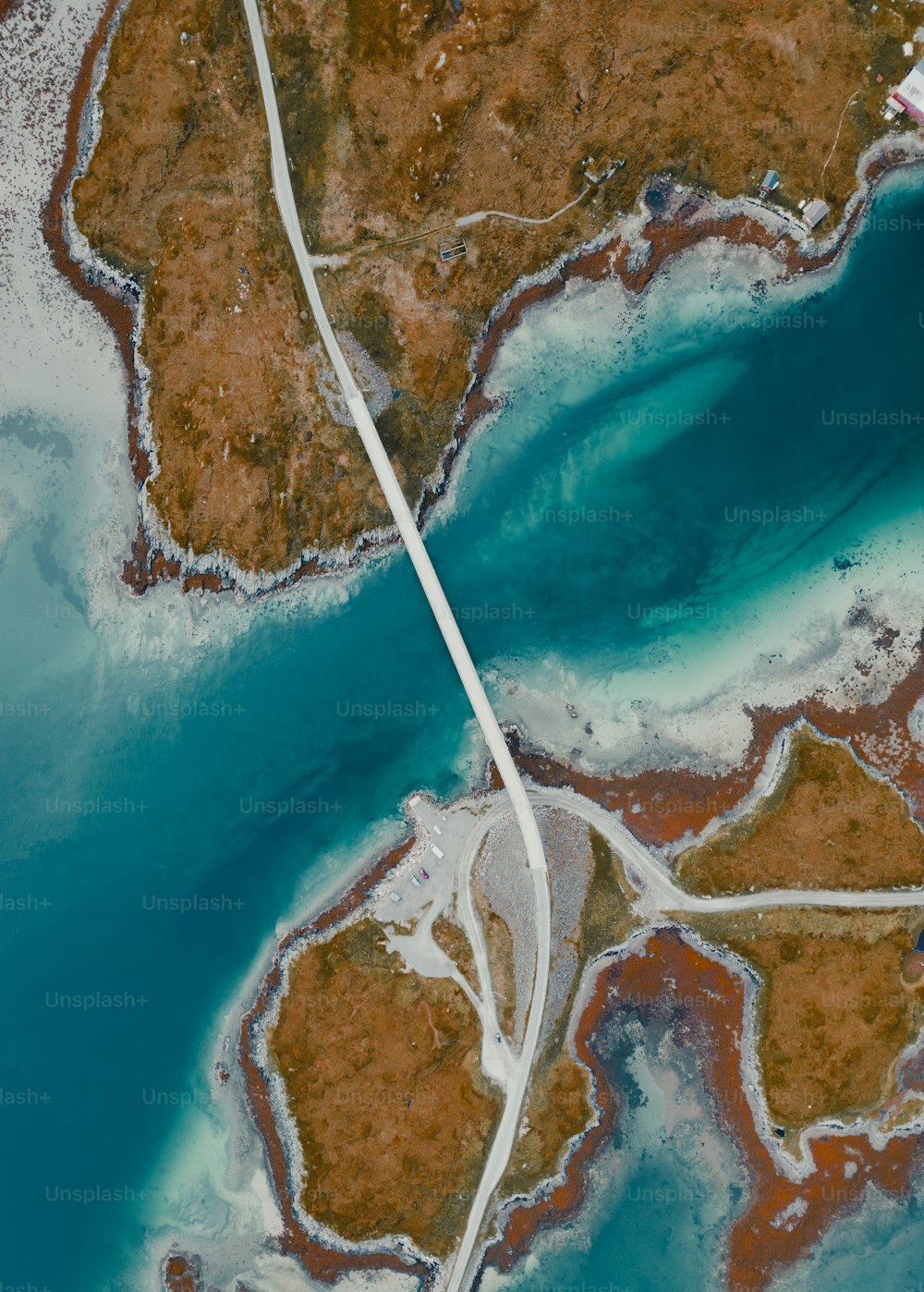 an aerial view of a road running through a body of water