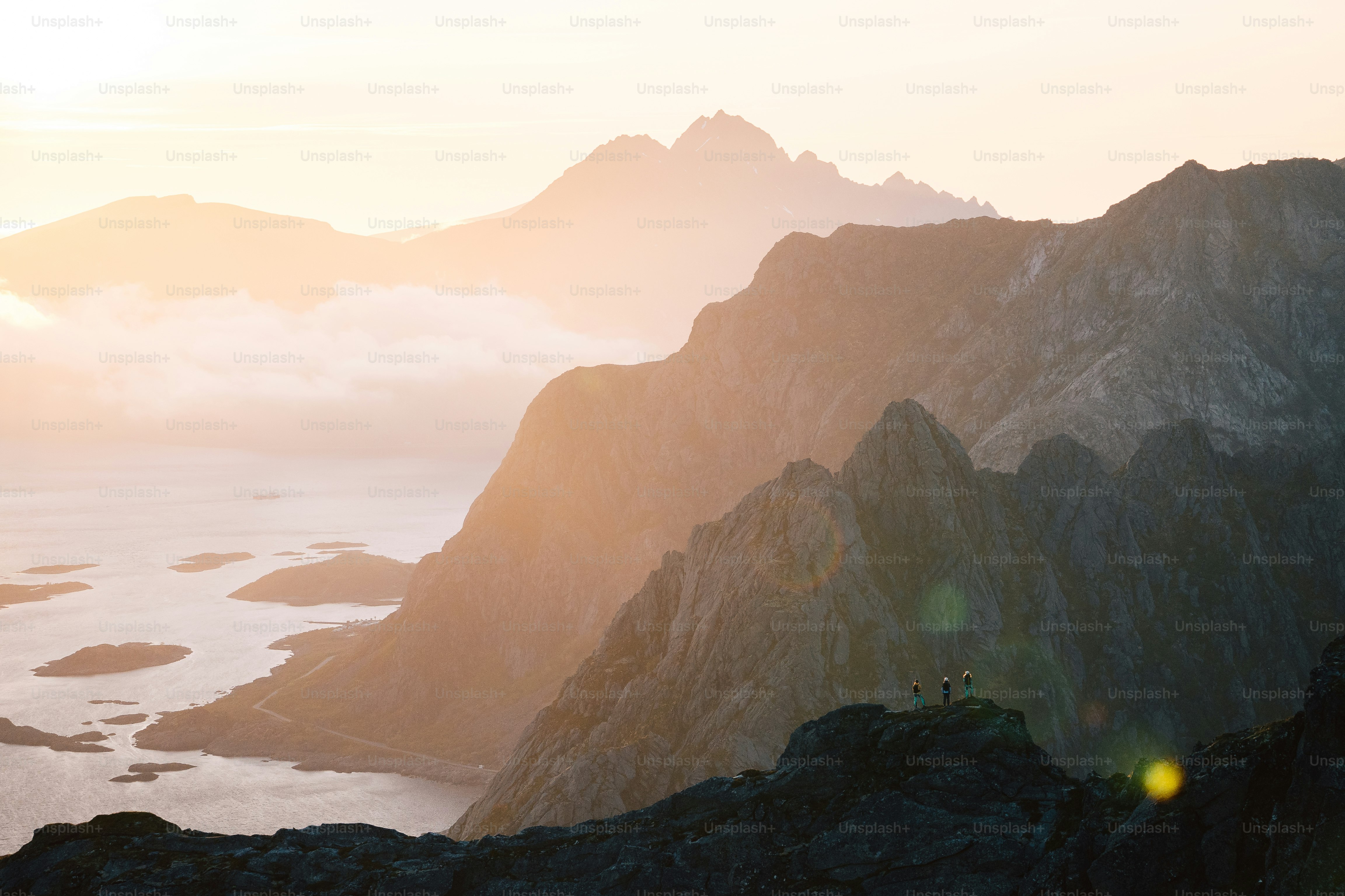 a couple of people standing on top of a mountain
