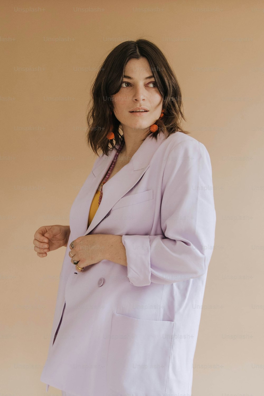 a woman wearing a purple jacket and a yellow tie