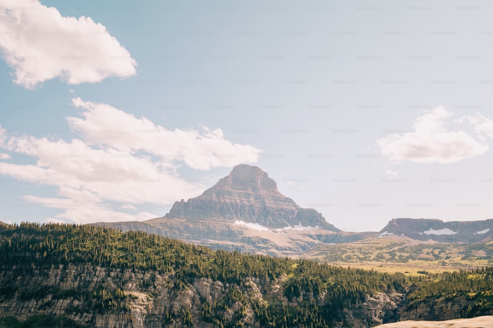 a view of a mountain range with trees in the foreground