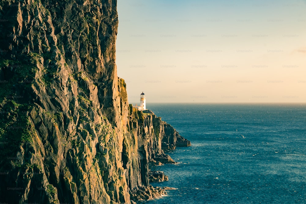 a lighthouse on a cliff overlooking the ocean