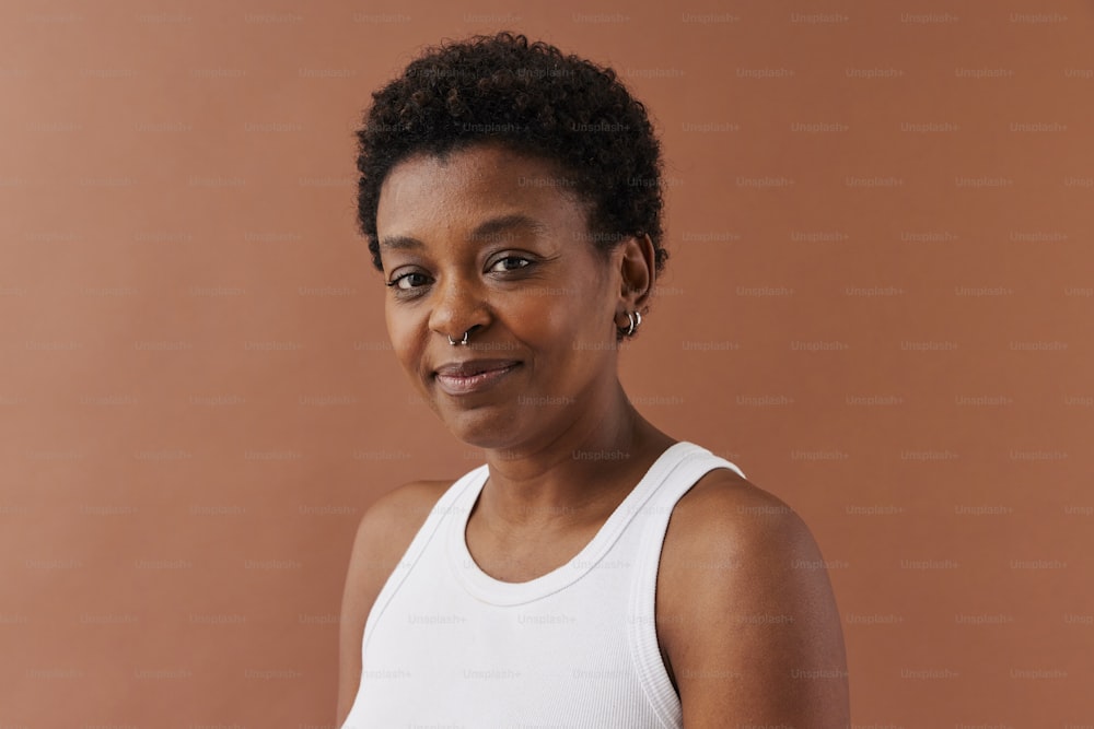 a woman in a white tank top posing for a picture