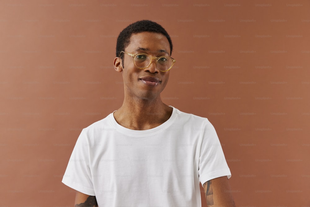 a man wearing glasses and a white t - shirt