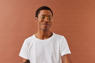 a man wearing glasses and a white t - shirt