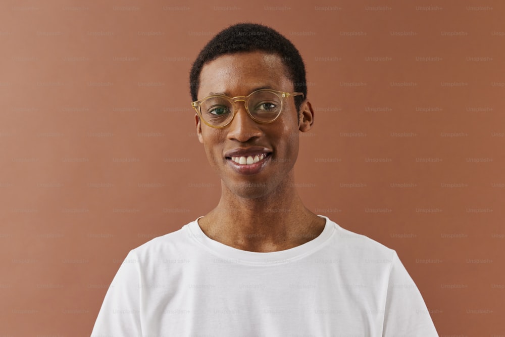 a man wearing glasses and a white t - shirt