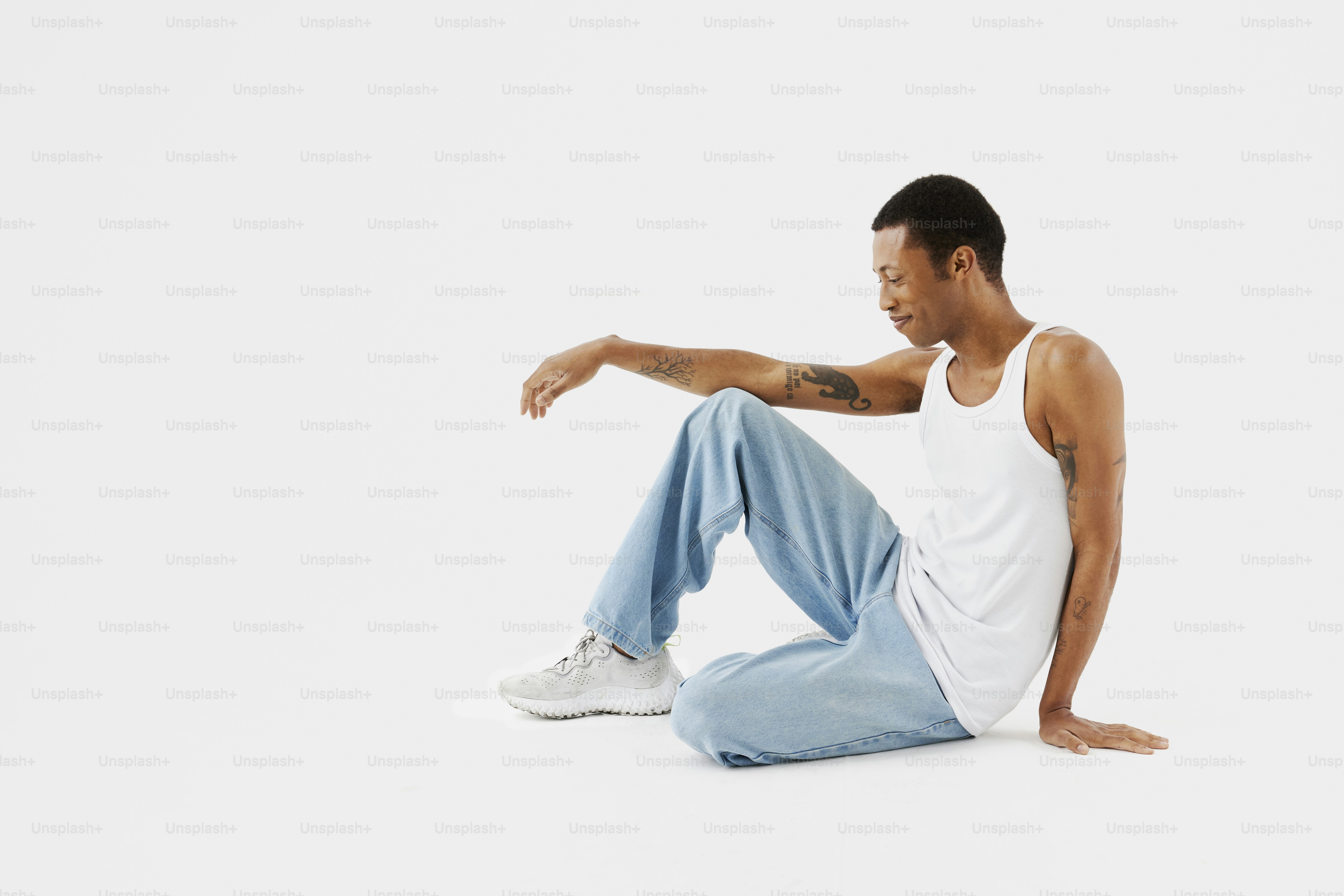 a man sitting on the ground with his legs crossed
