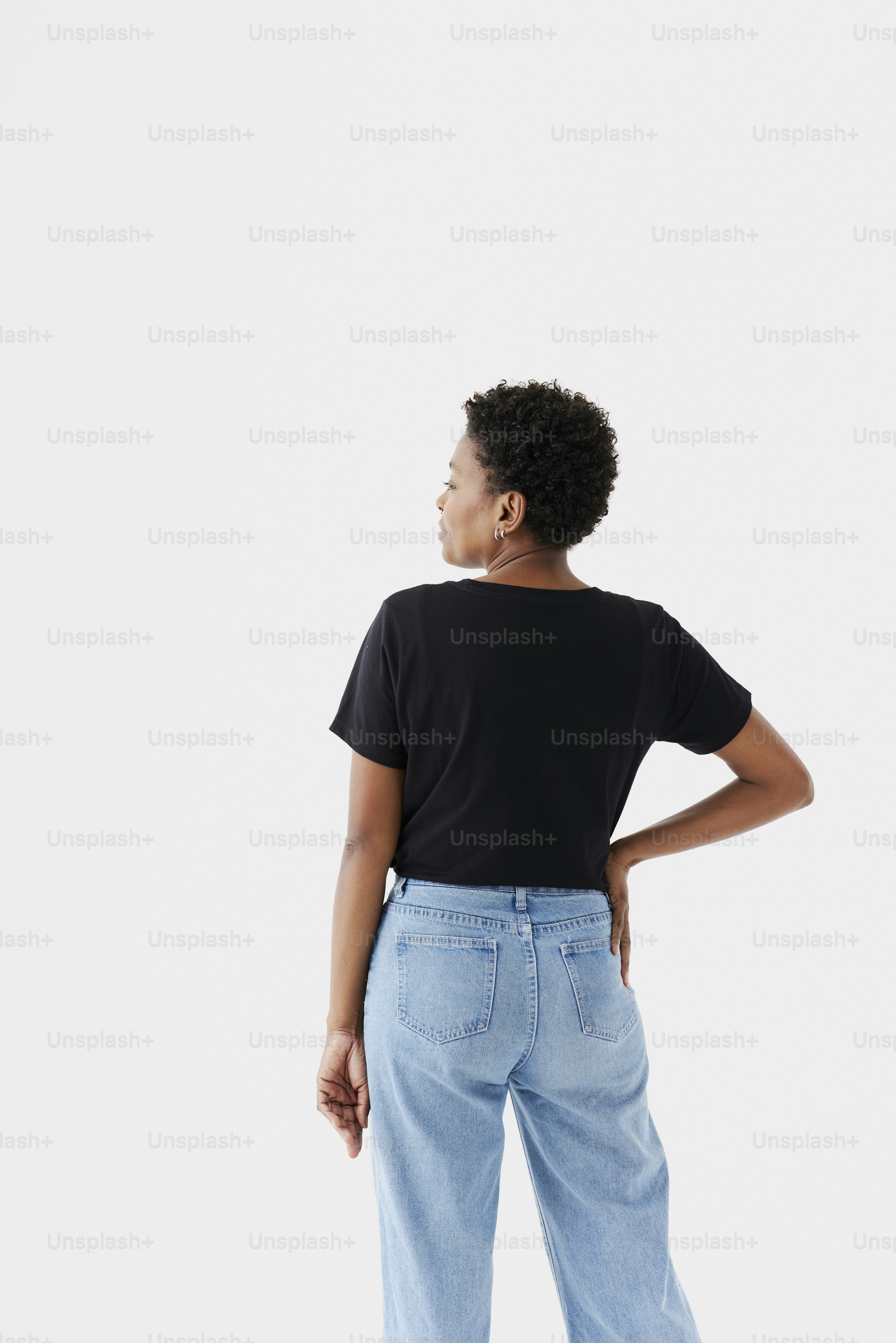 a woman in a black shirt and light blue jeans