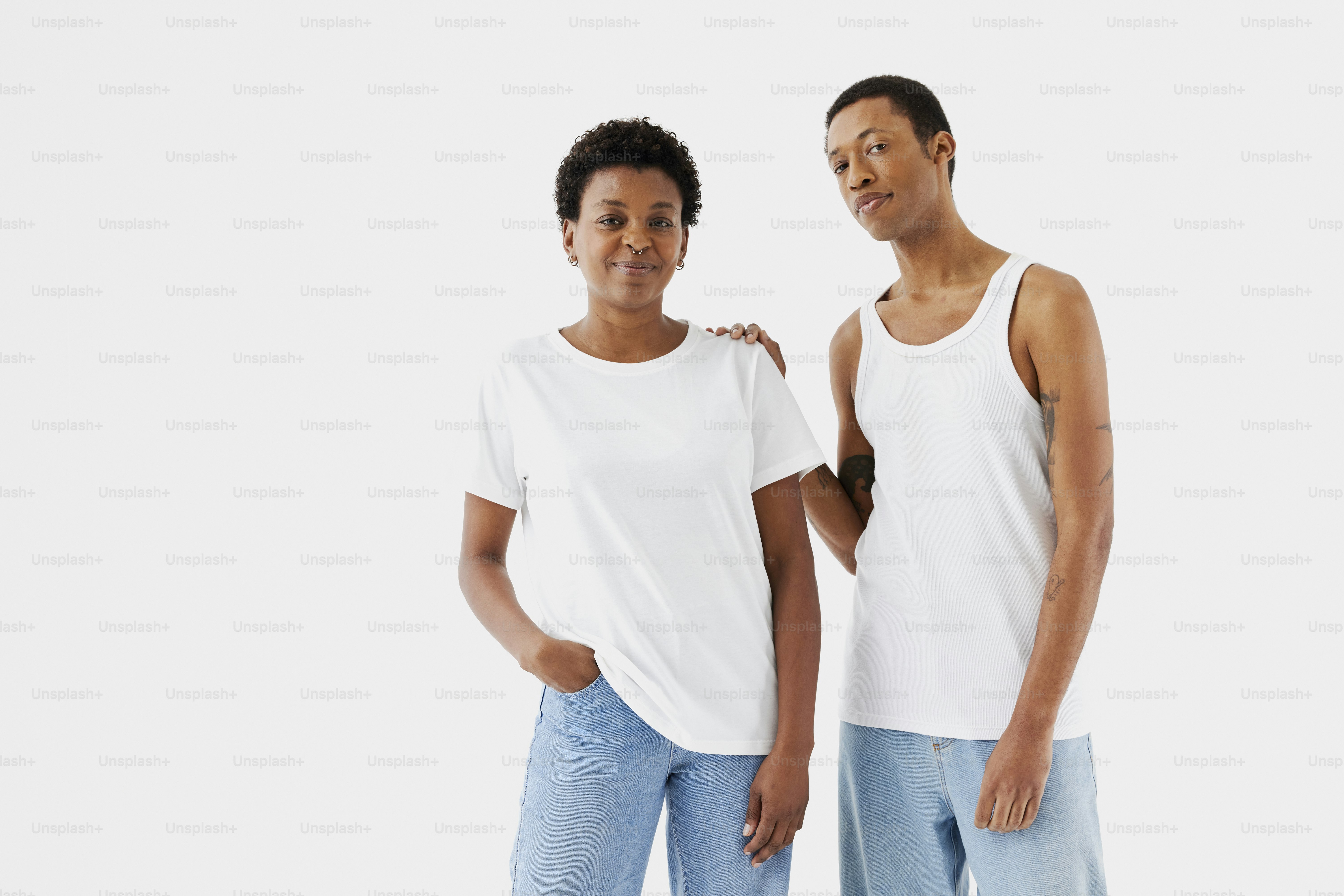 Two people standing next to each other in front of a white background ...