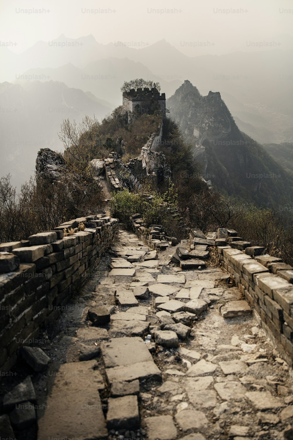 a stone path leading to a castle on top of a mountain