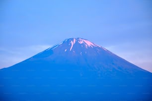 a large mountain with snow on top of it