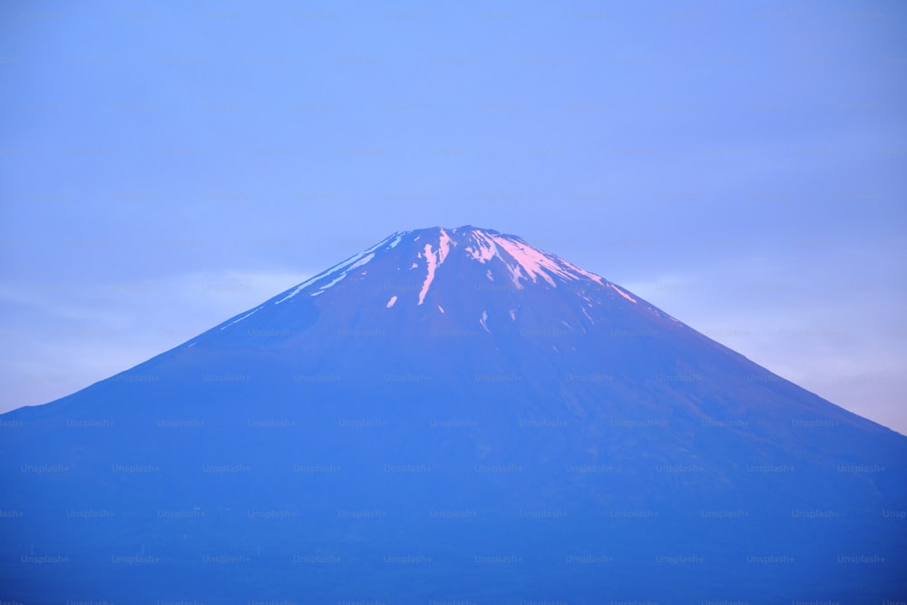 a large mountain with snow on top of it