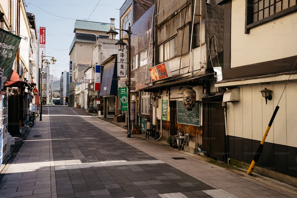 a narrow city street lined with buildings and shops