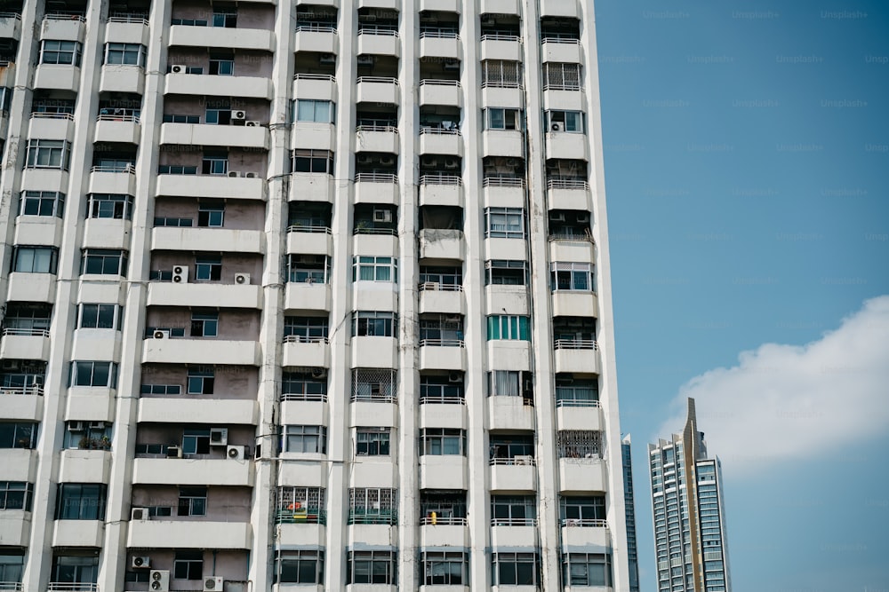 Un edificio alto y blanco con balcones y ventanas