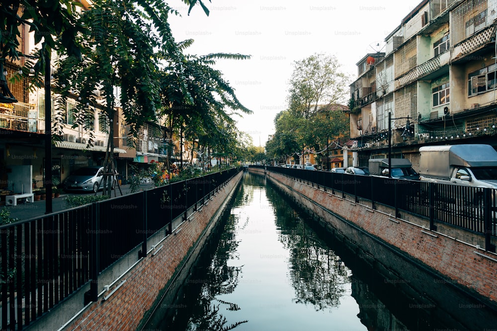 a canal running through a city next to tall buildings