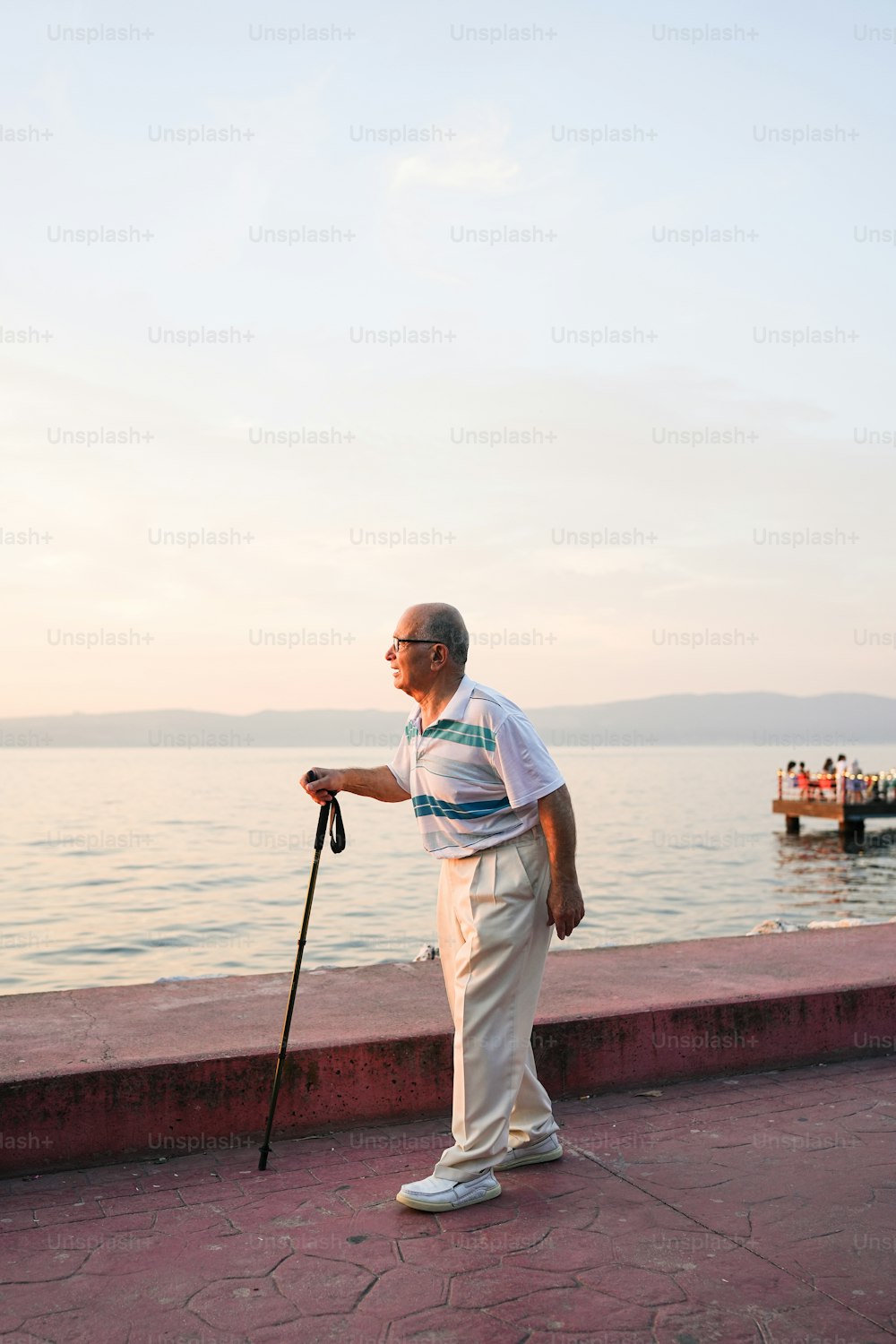 a man standing next to a body of water