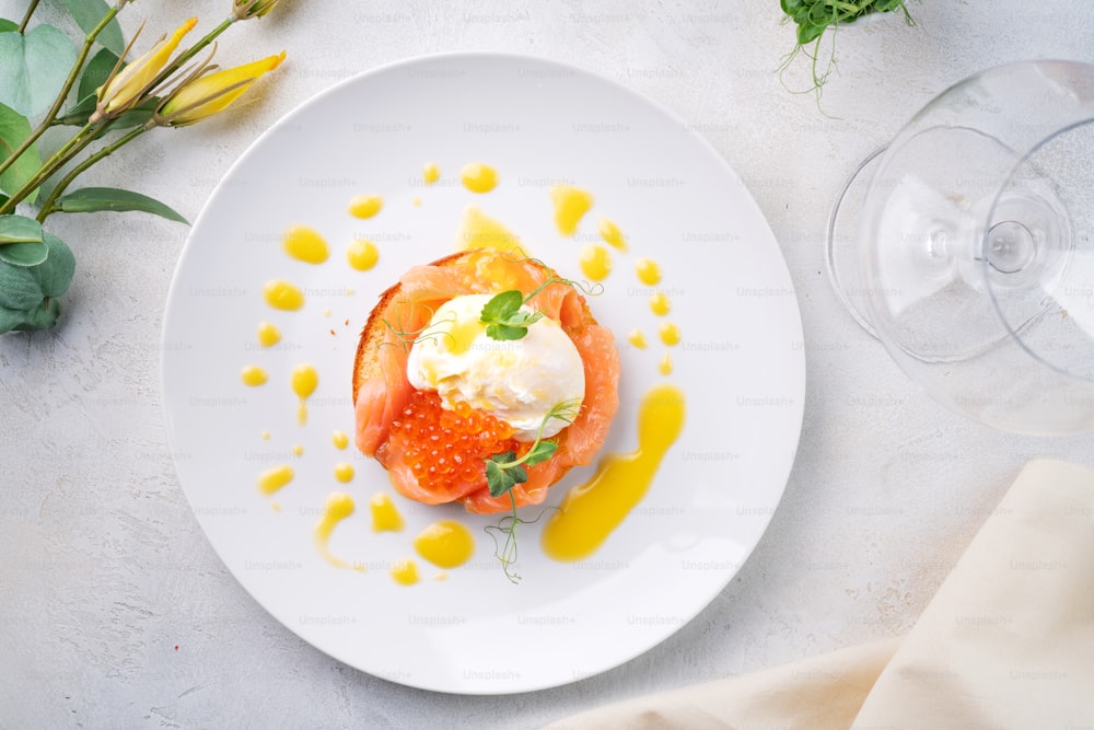 a plate of food on a table with a glass of wine