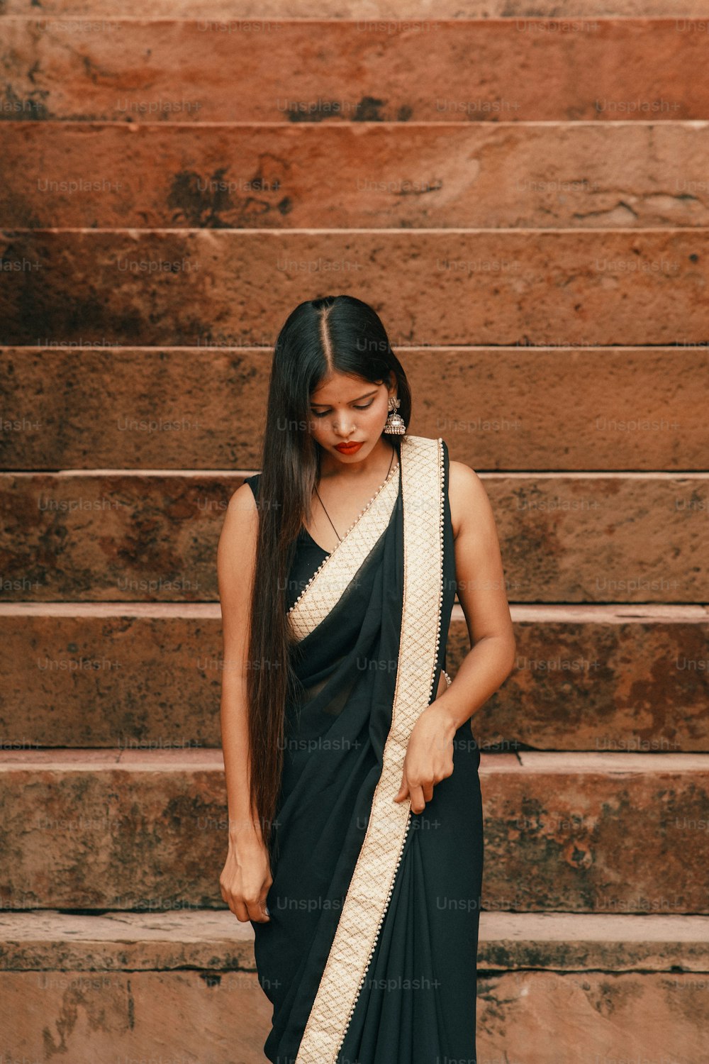 a woman in a black and white sari