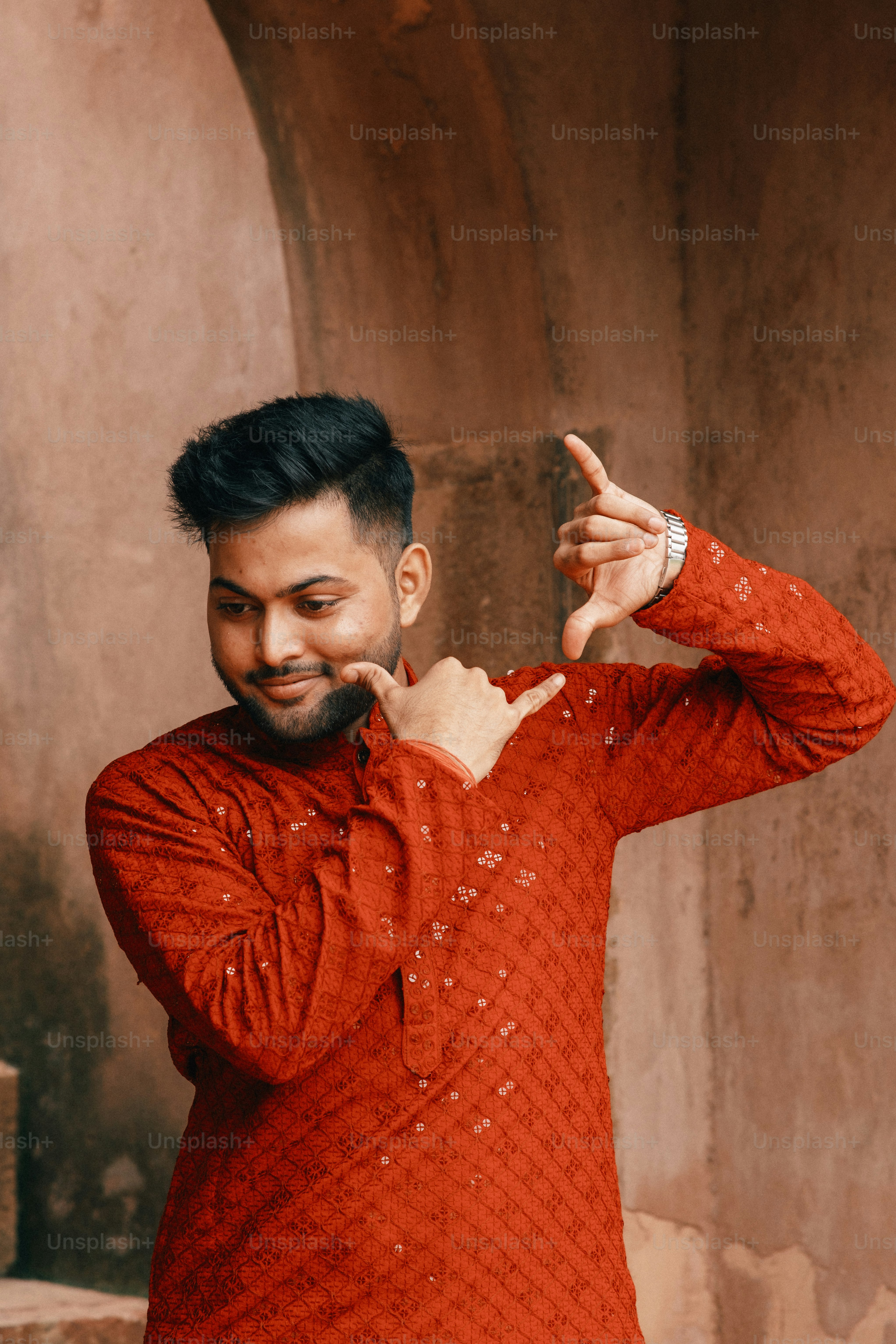 a man in a red shirt pointing at something