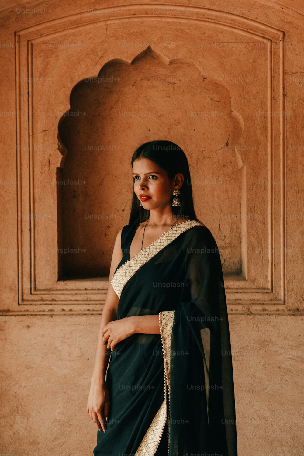 a woman in a black and white sari