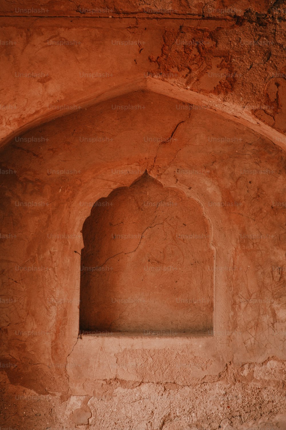 a stone arch with a window in it