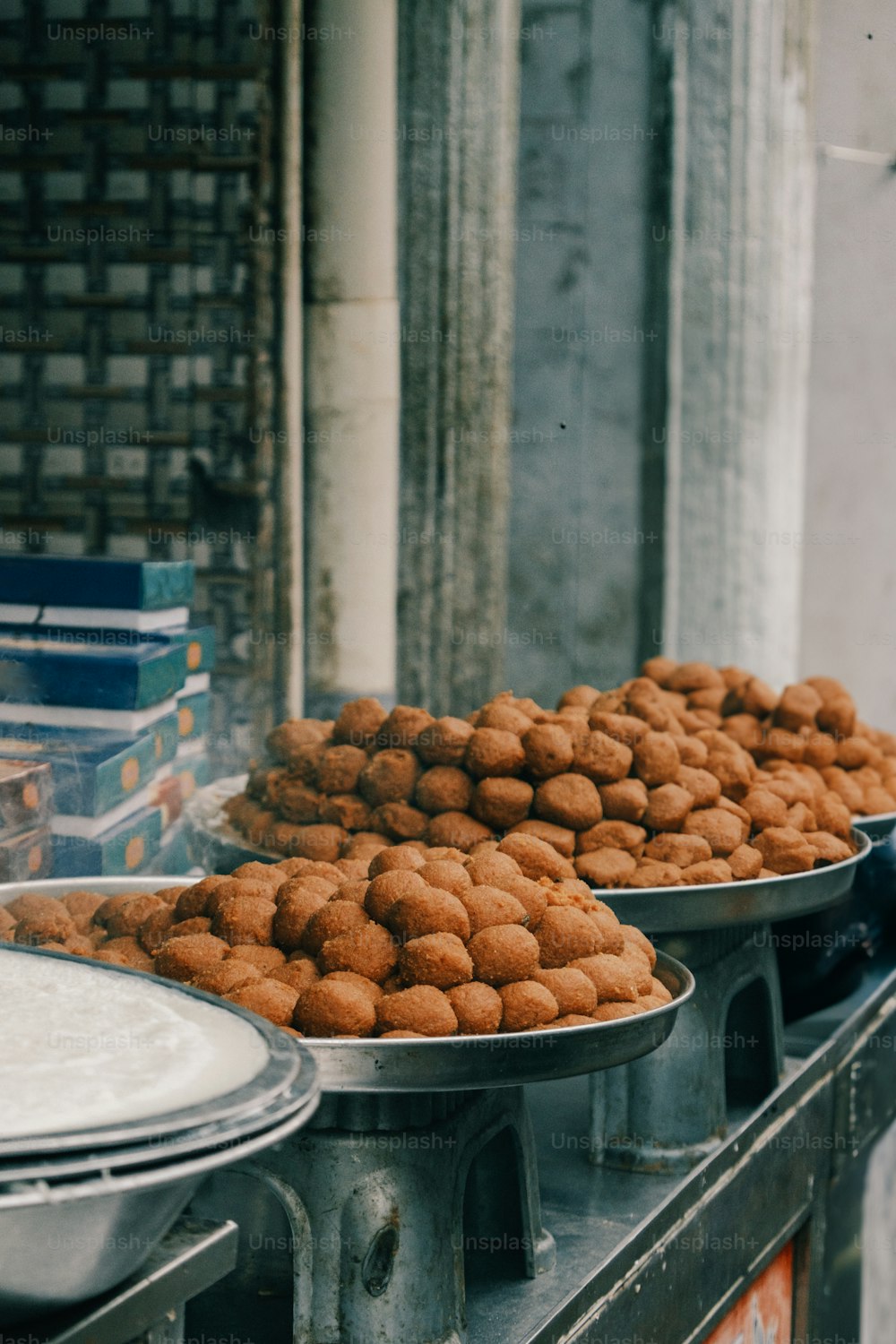 two metal trays filled with food on top of a table