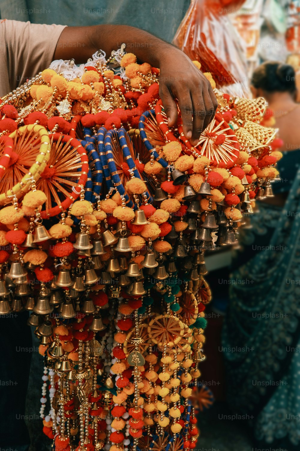 a man is holding a bunch of jewelry