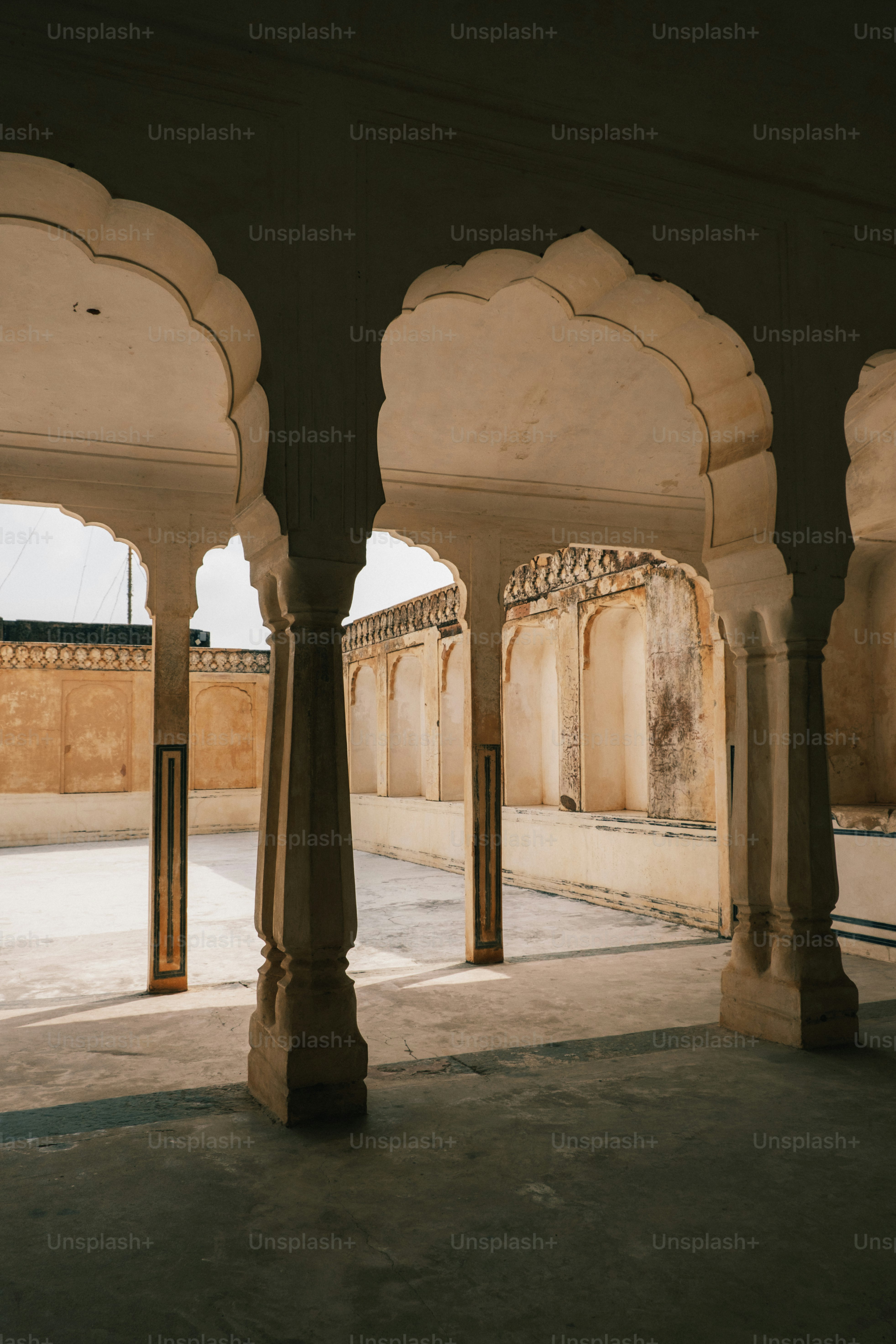 an archway in a building with a clock on the wall