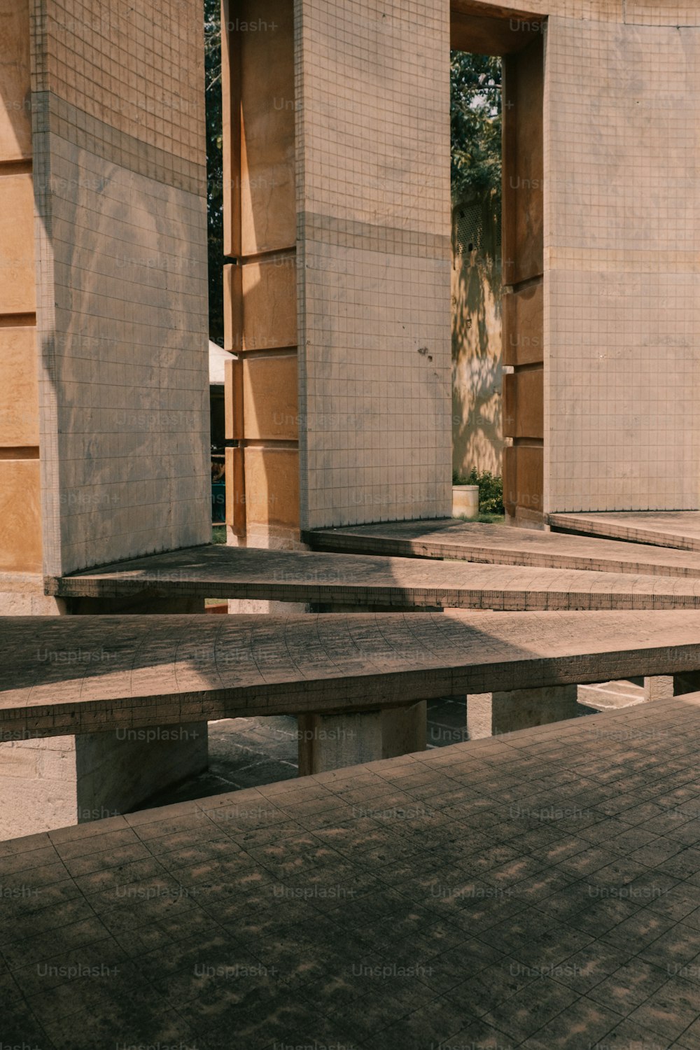 a row of concrete benches in front of a building