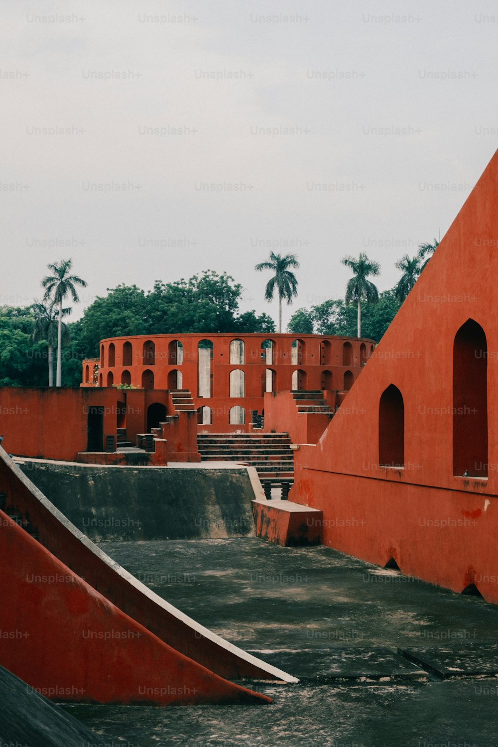 a skateboard park with a ramp and a building in the background