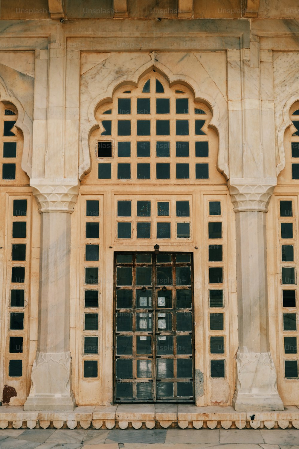 a stone building with a large window and a clock