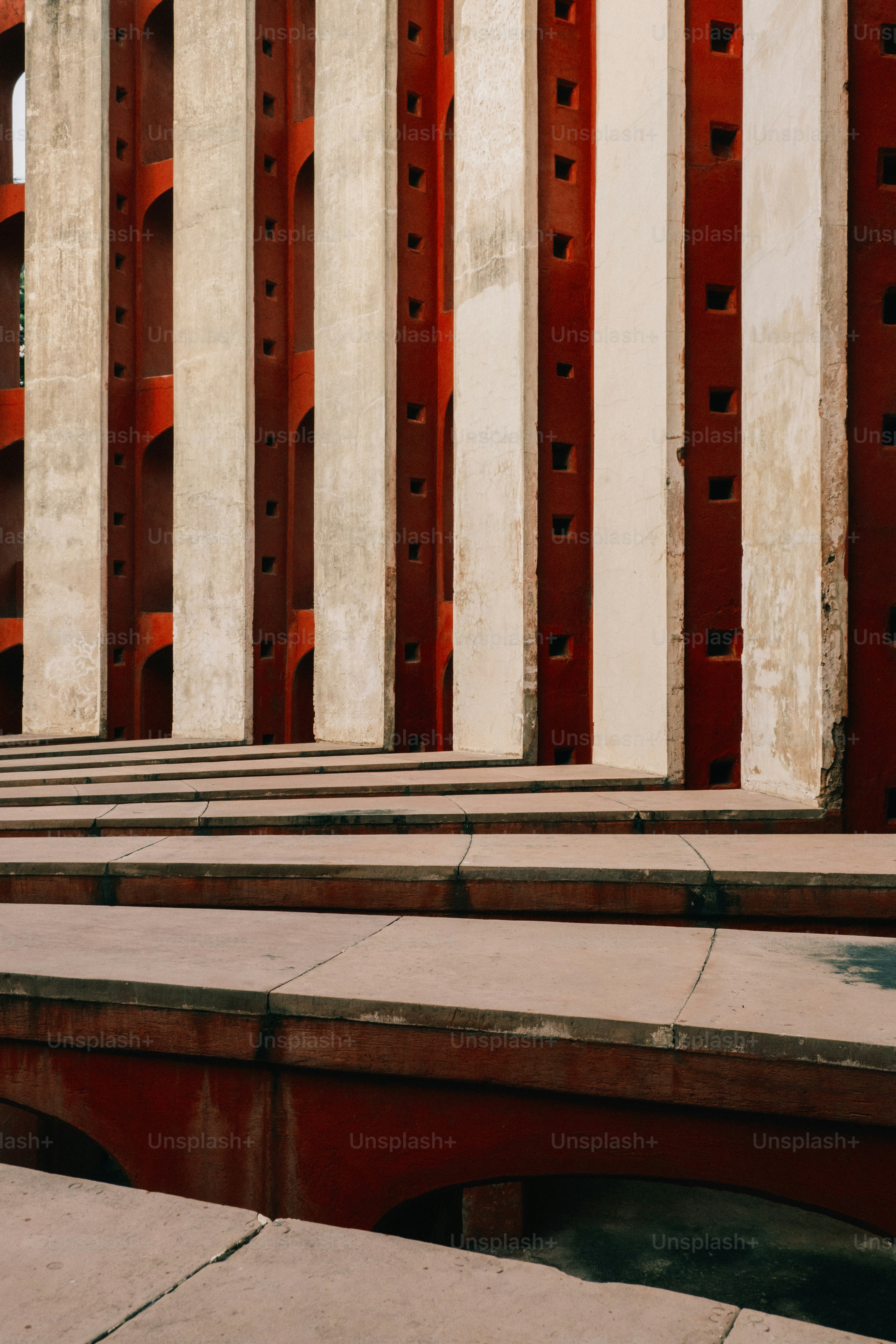 a row of benches sitting in front of a tall building