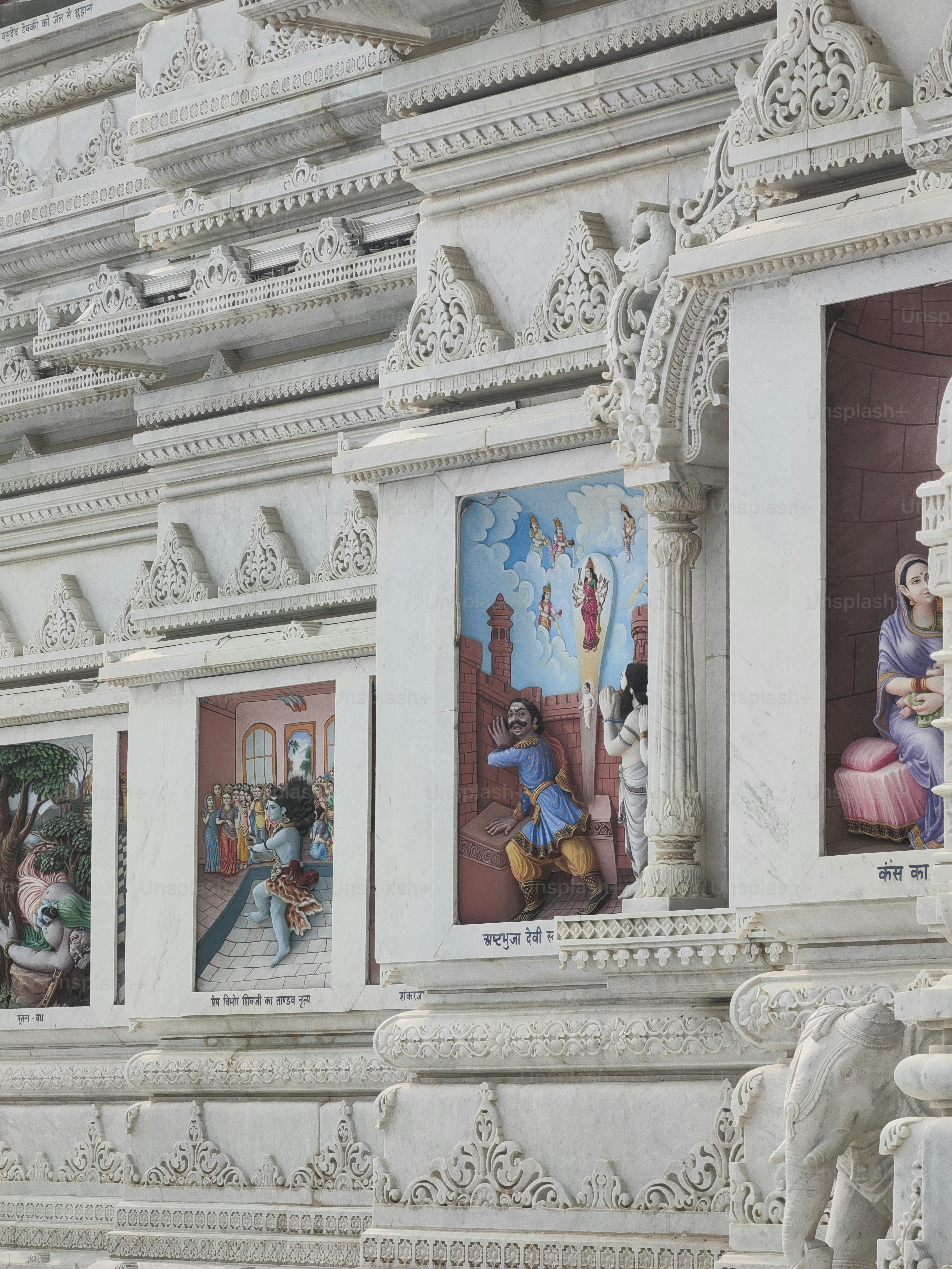 a white building with a bunch of paintings on it