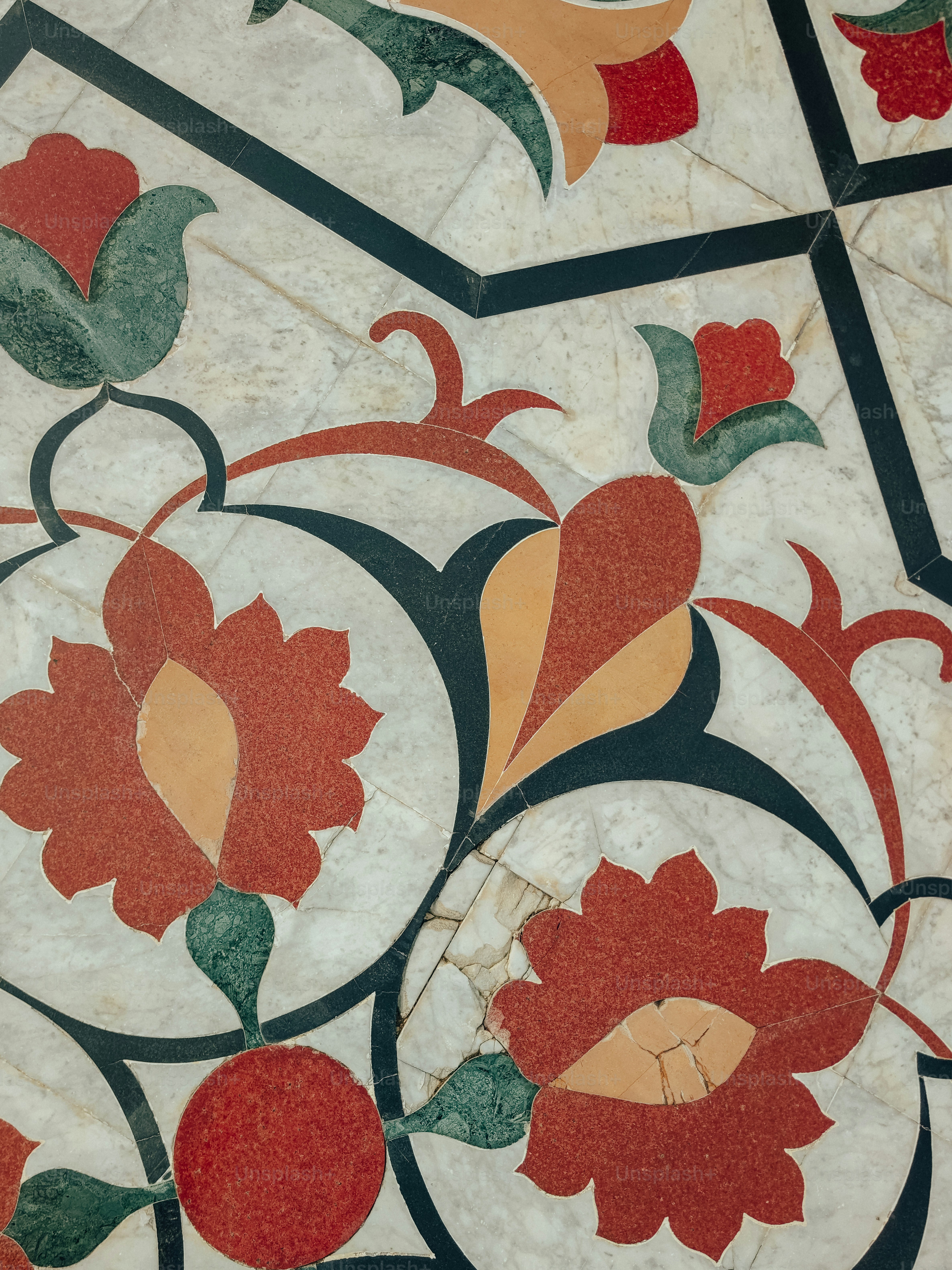 a close up of a tile with flowers on it