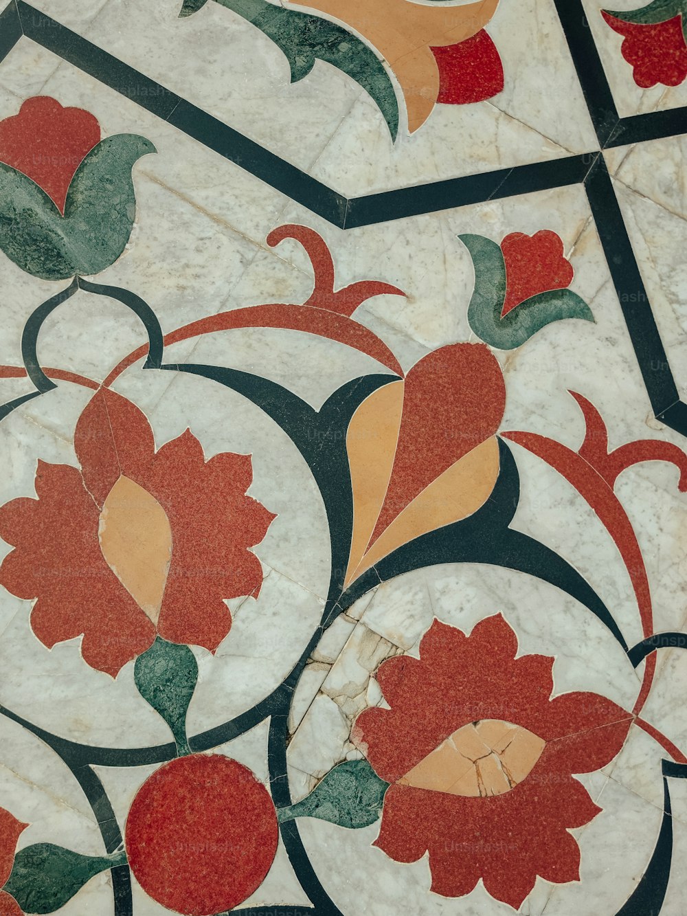 a close up of a tile with flowers on it