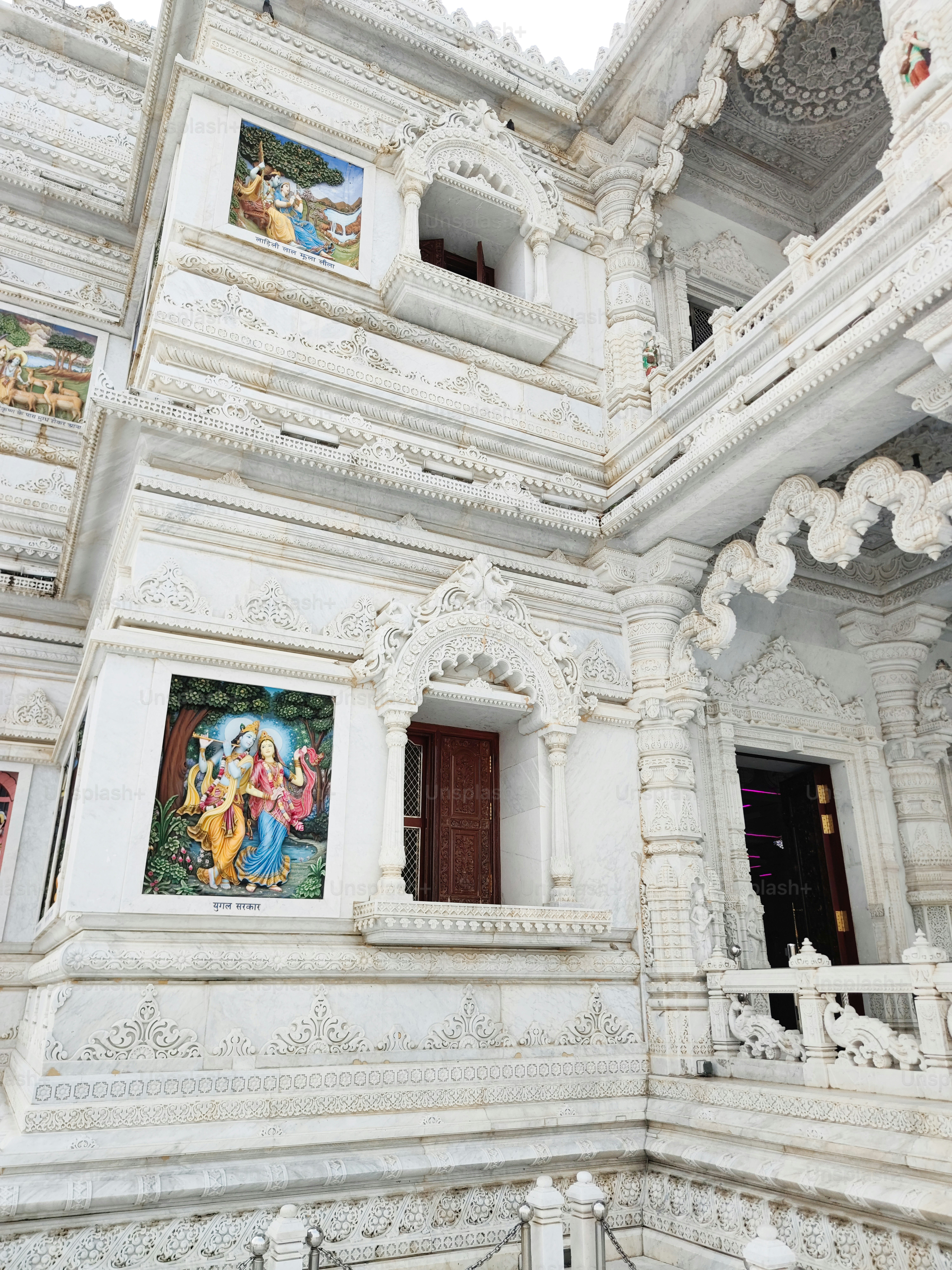 a white building with paintings on the walls