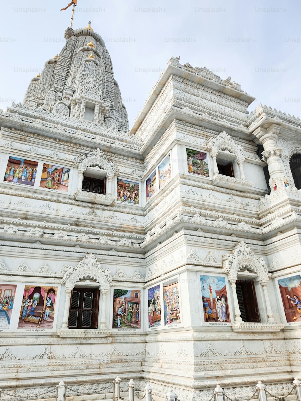 a large white building with paintings on the side of it