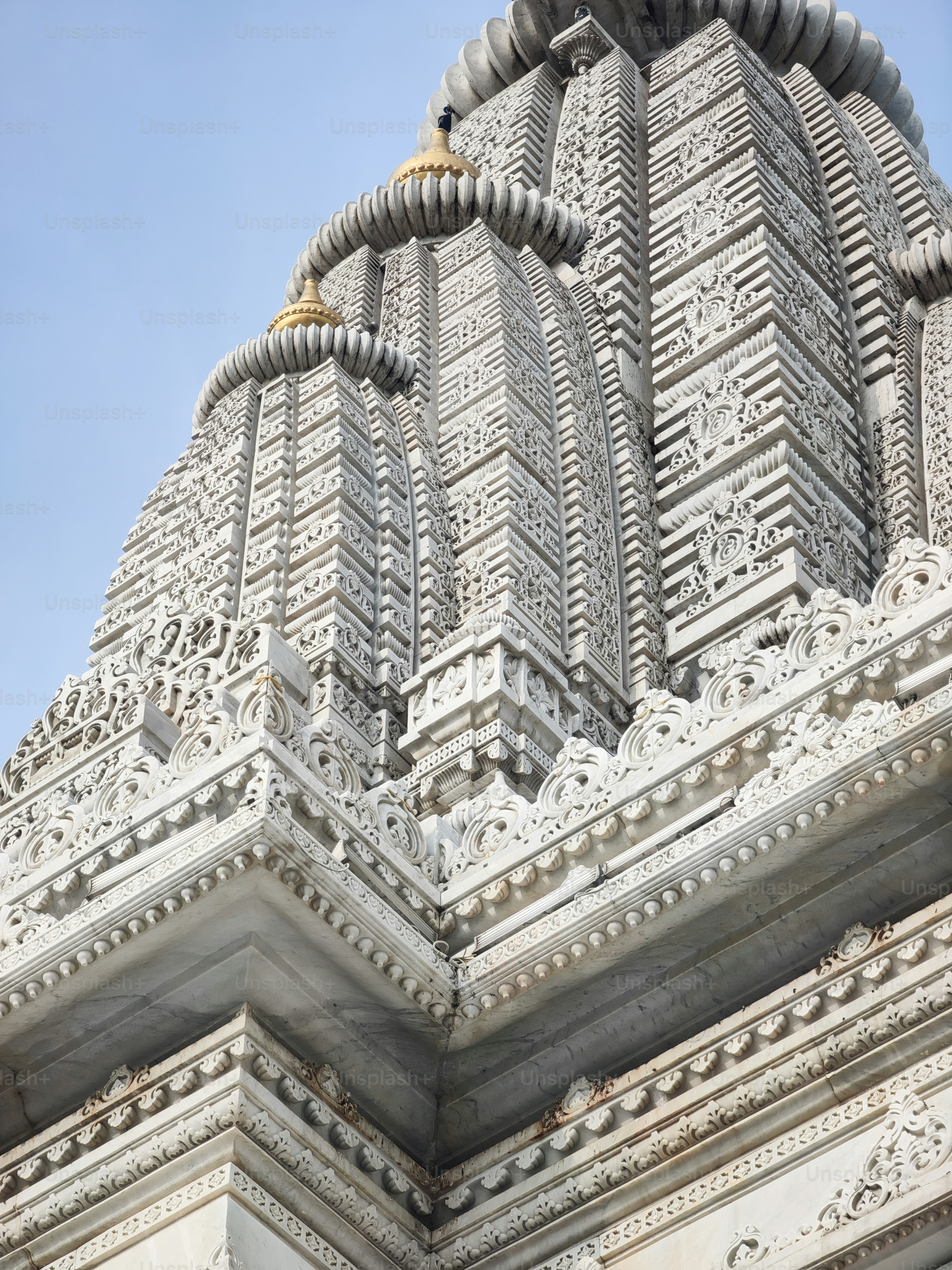a very tall white building with a clock on it's side