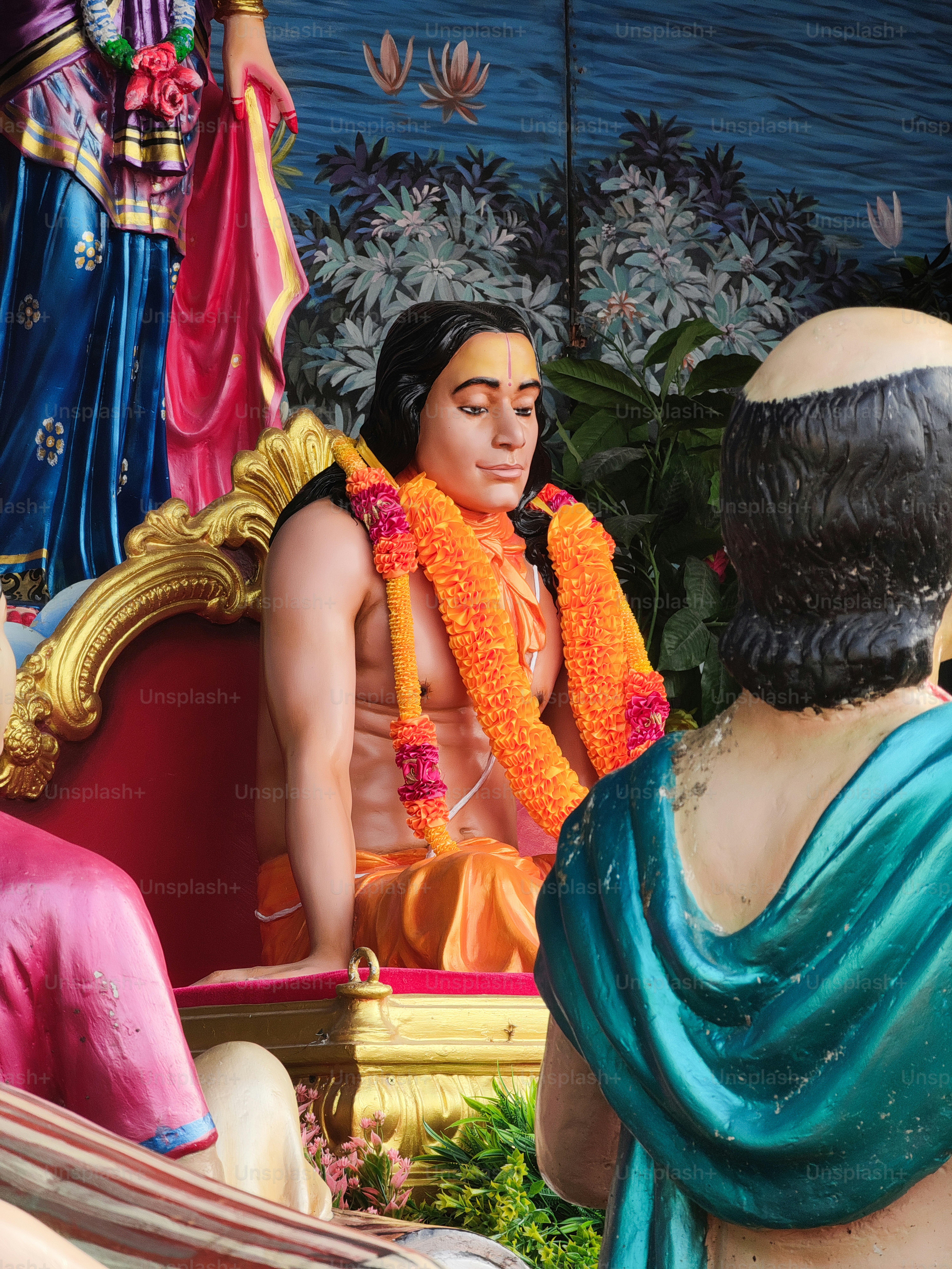 a statue of a man sitting next to a statue of a woman