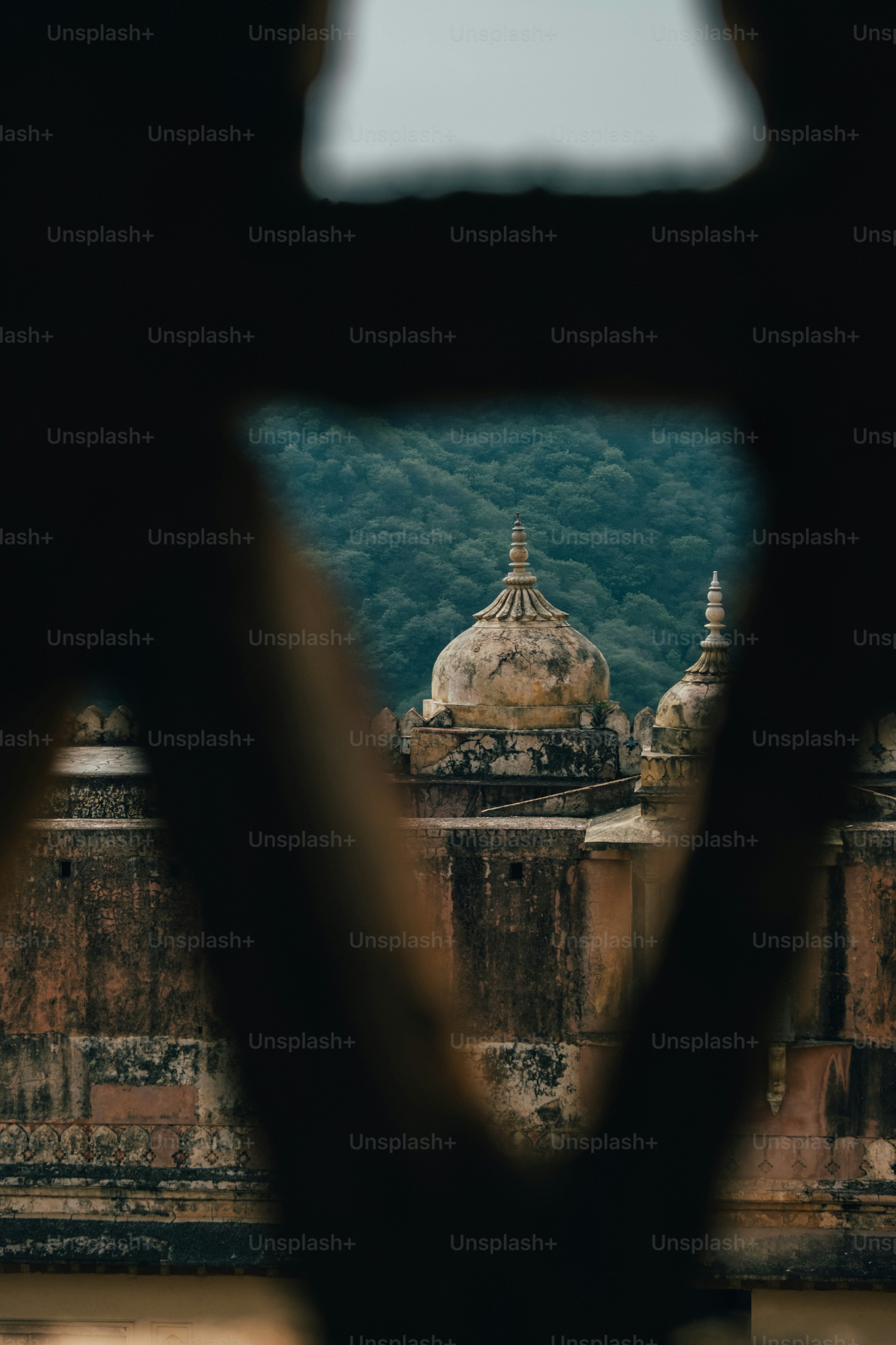 a view of a building through a hole in the wall