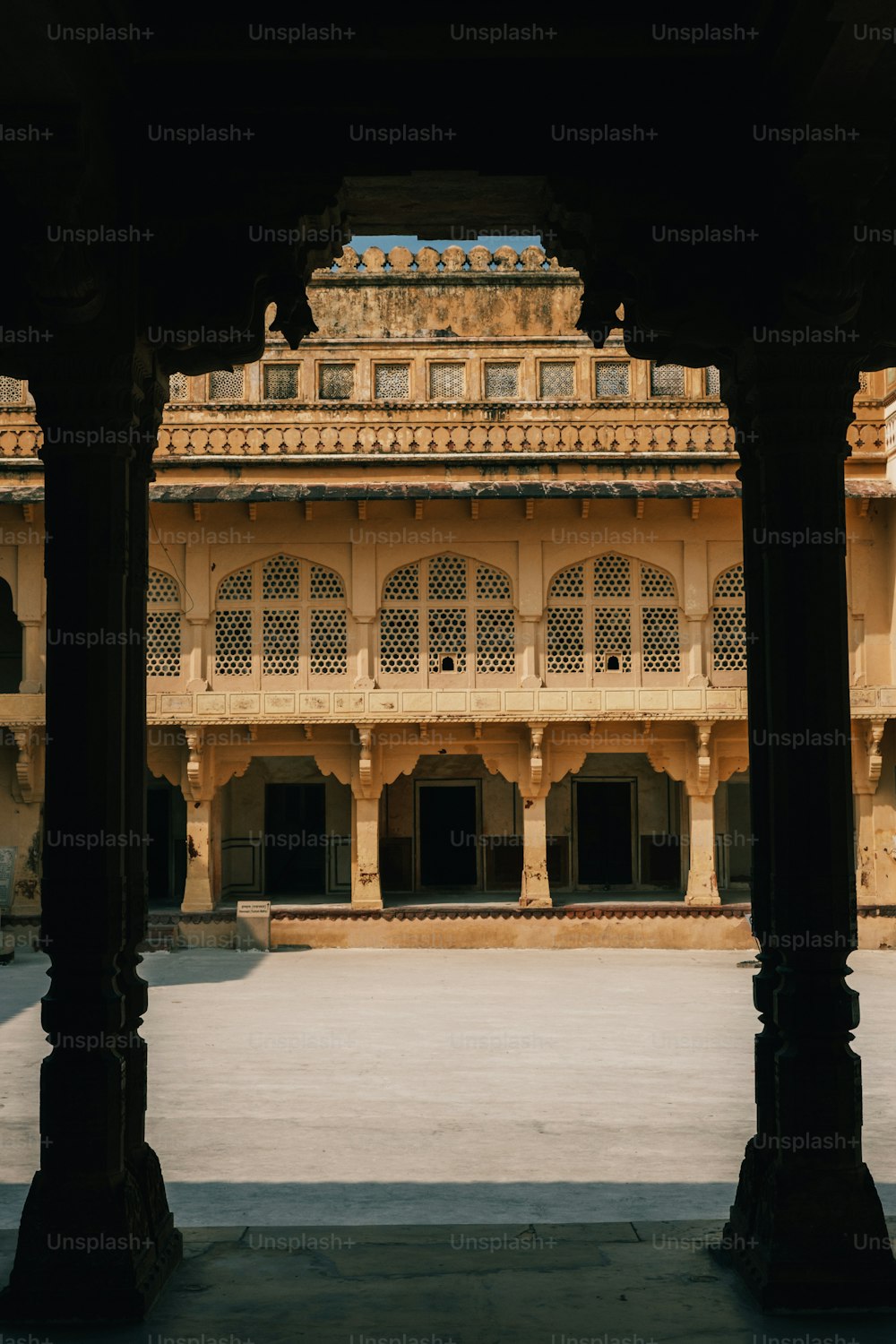 a view of a building through two pillars