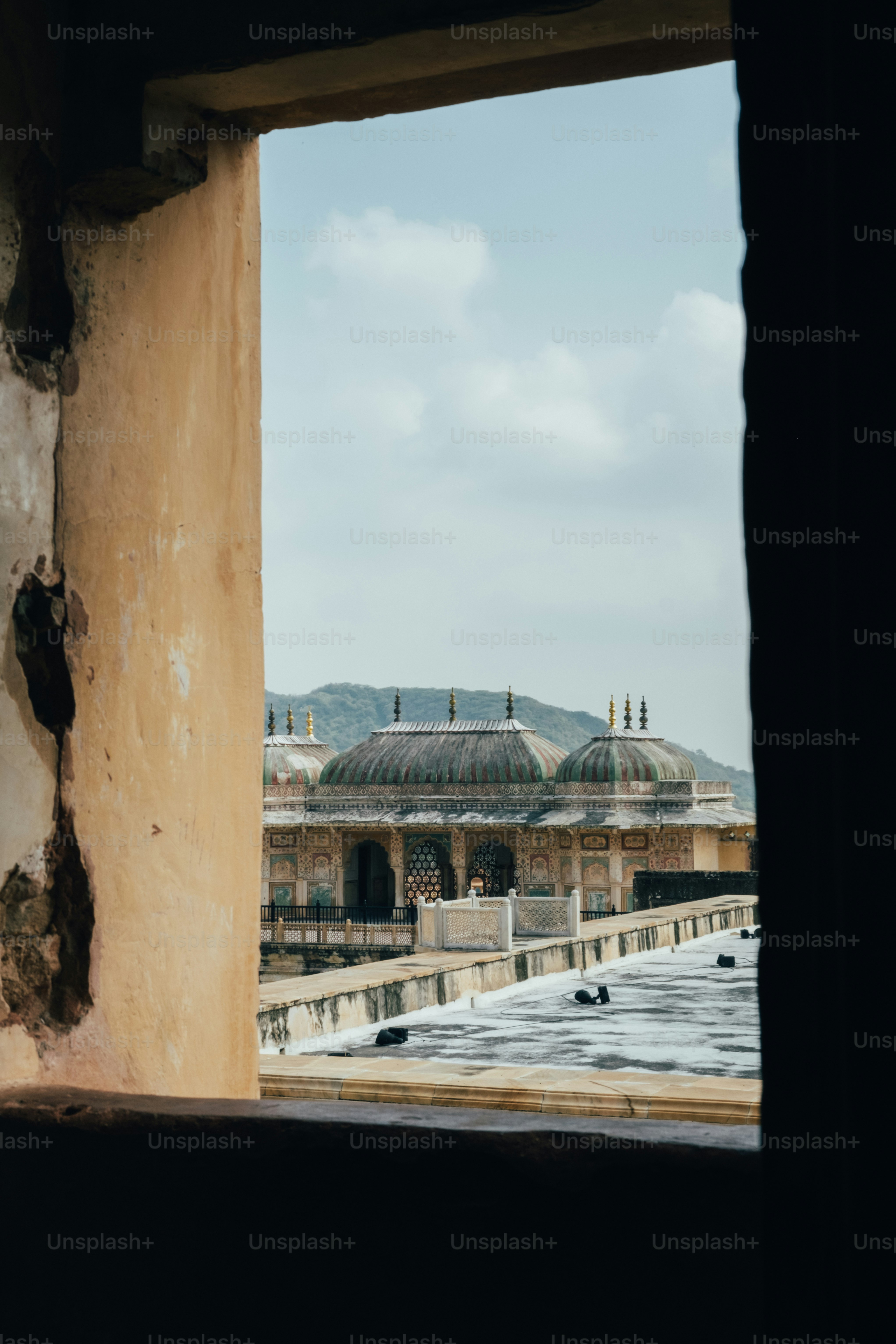 A view of a building through a window photo – Building Image on Unsplash