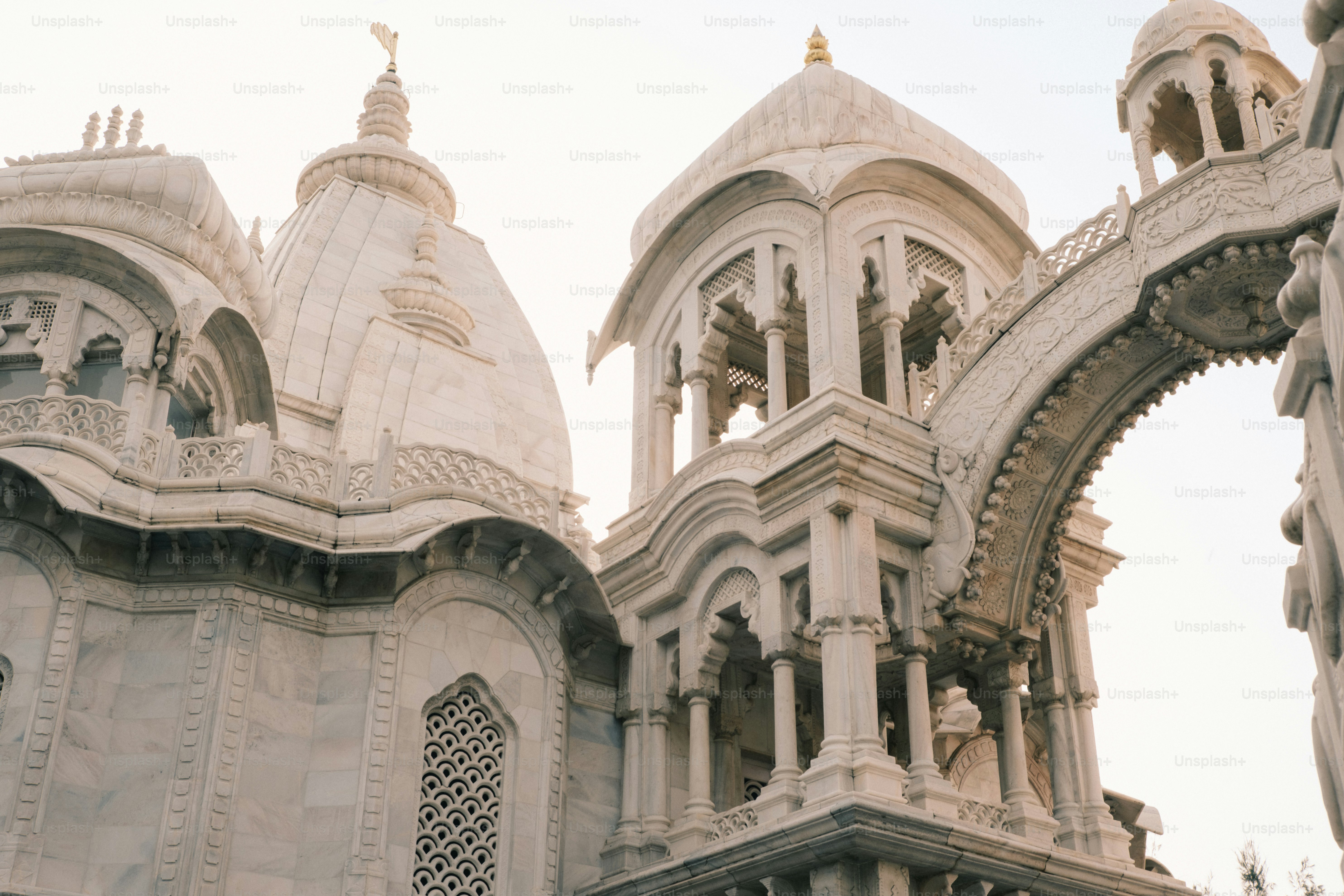 a large white building with a clock on it's side