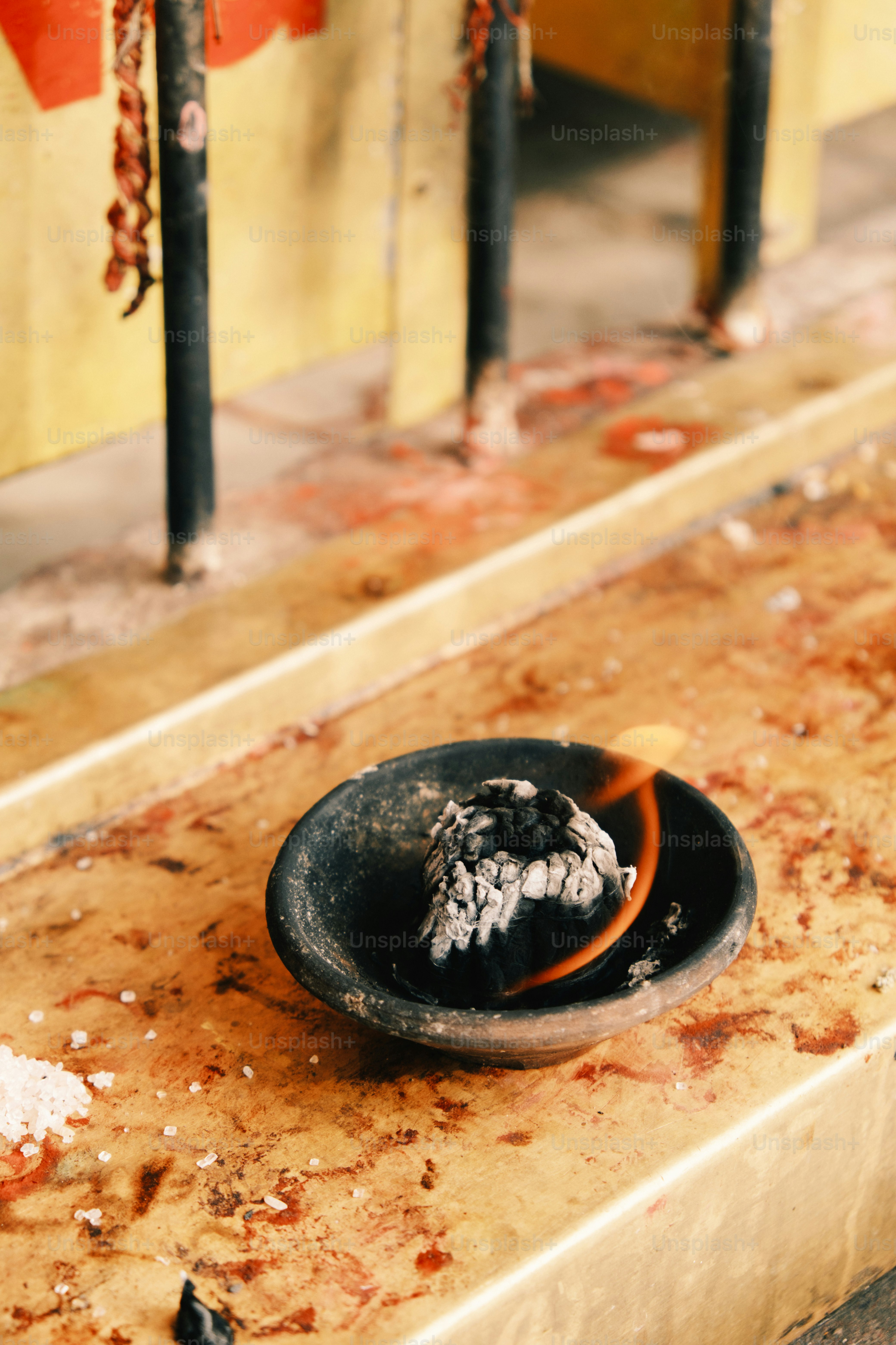 a black bowl sitting on top of a wooden table