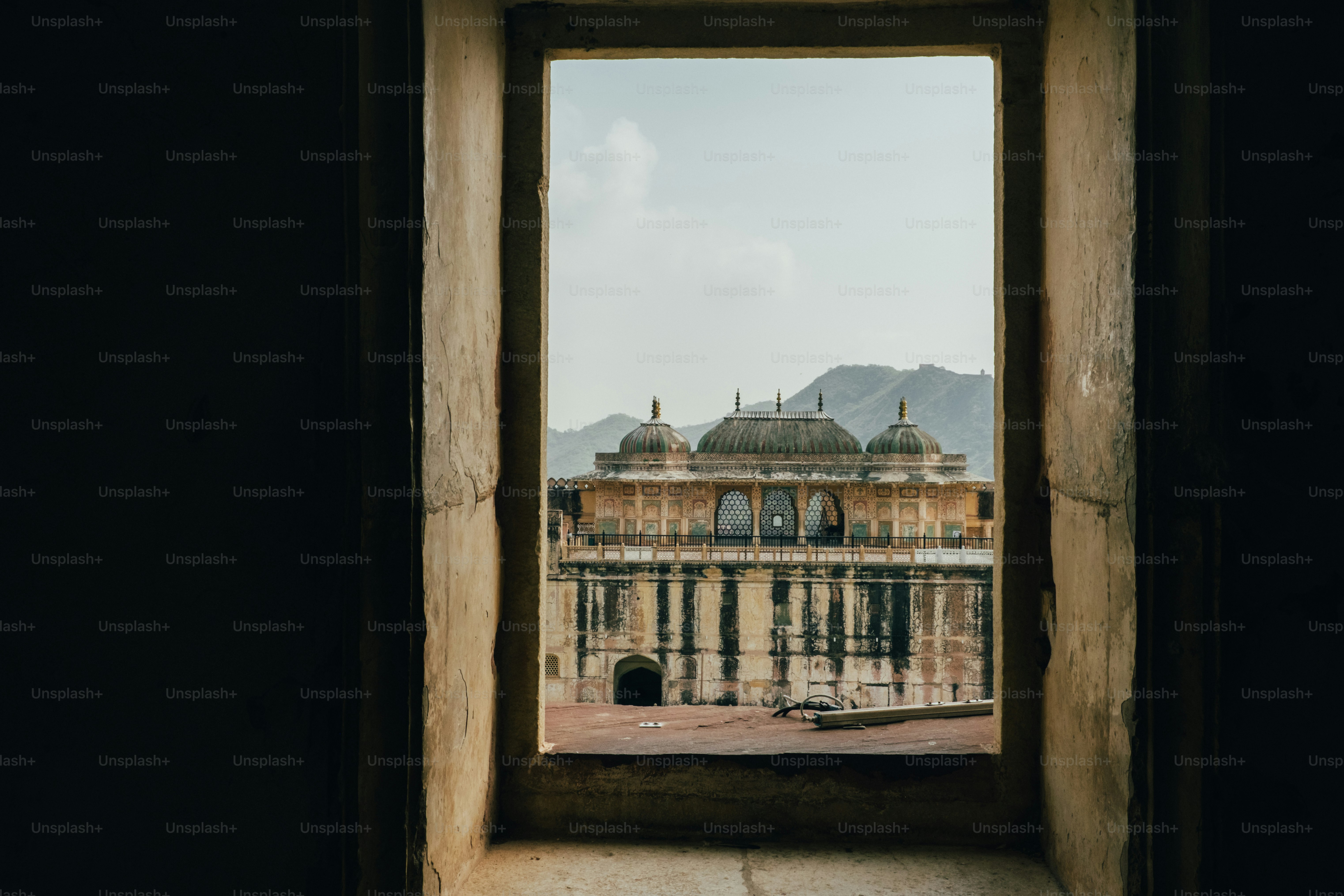 A view of a building through a window photo – Domes Image on Unsplash