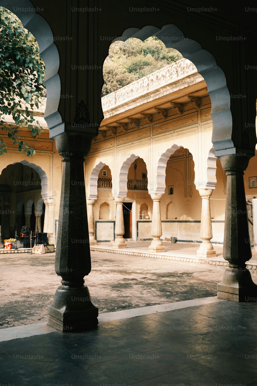 a building with arches and pillars in a courtyard