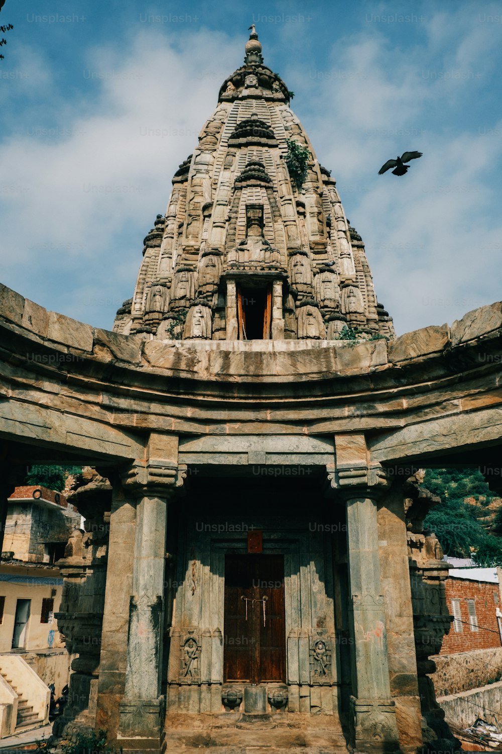 a large stone structure with a bird flying over it